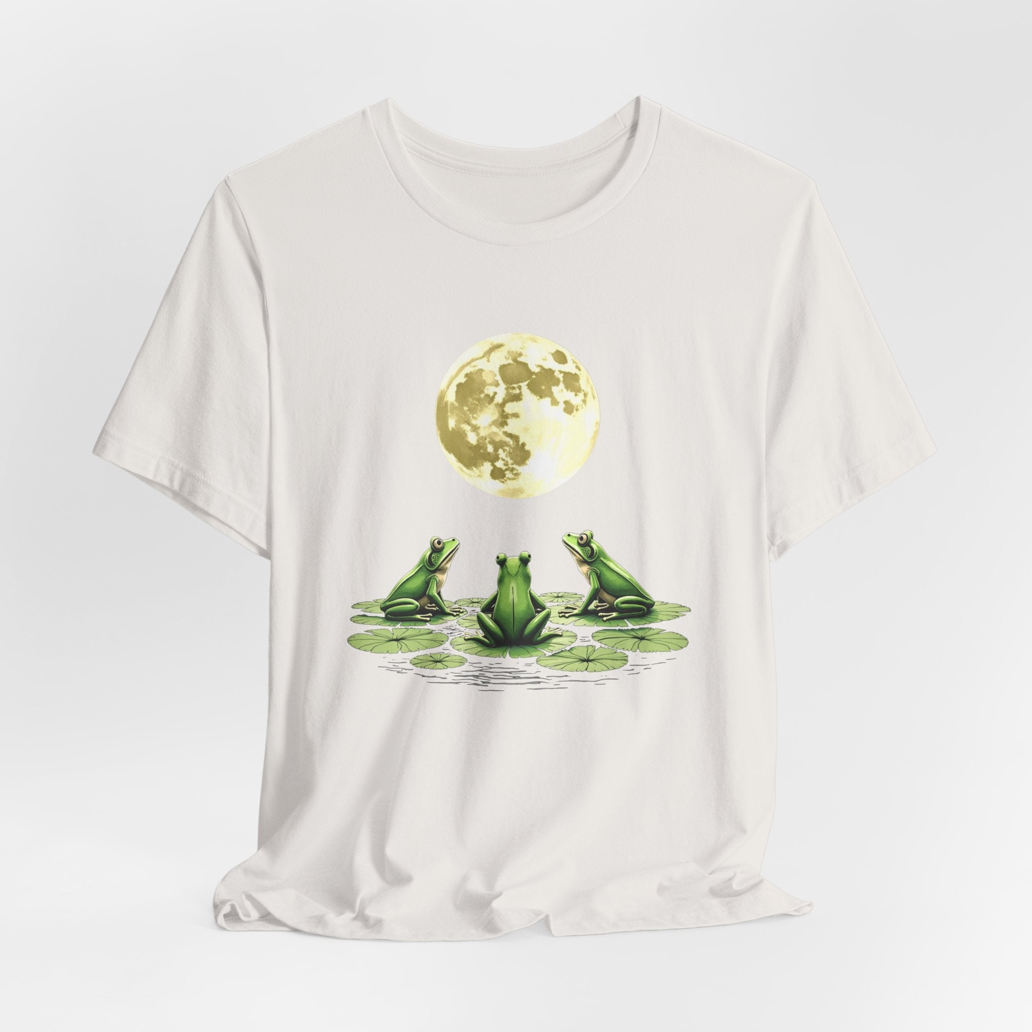 Vintage white t-shirt featuring cute frogs sitting on top of water lily watching on the moon graphic on a white background