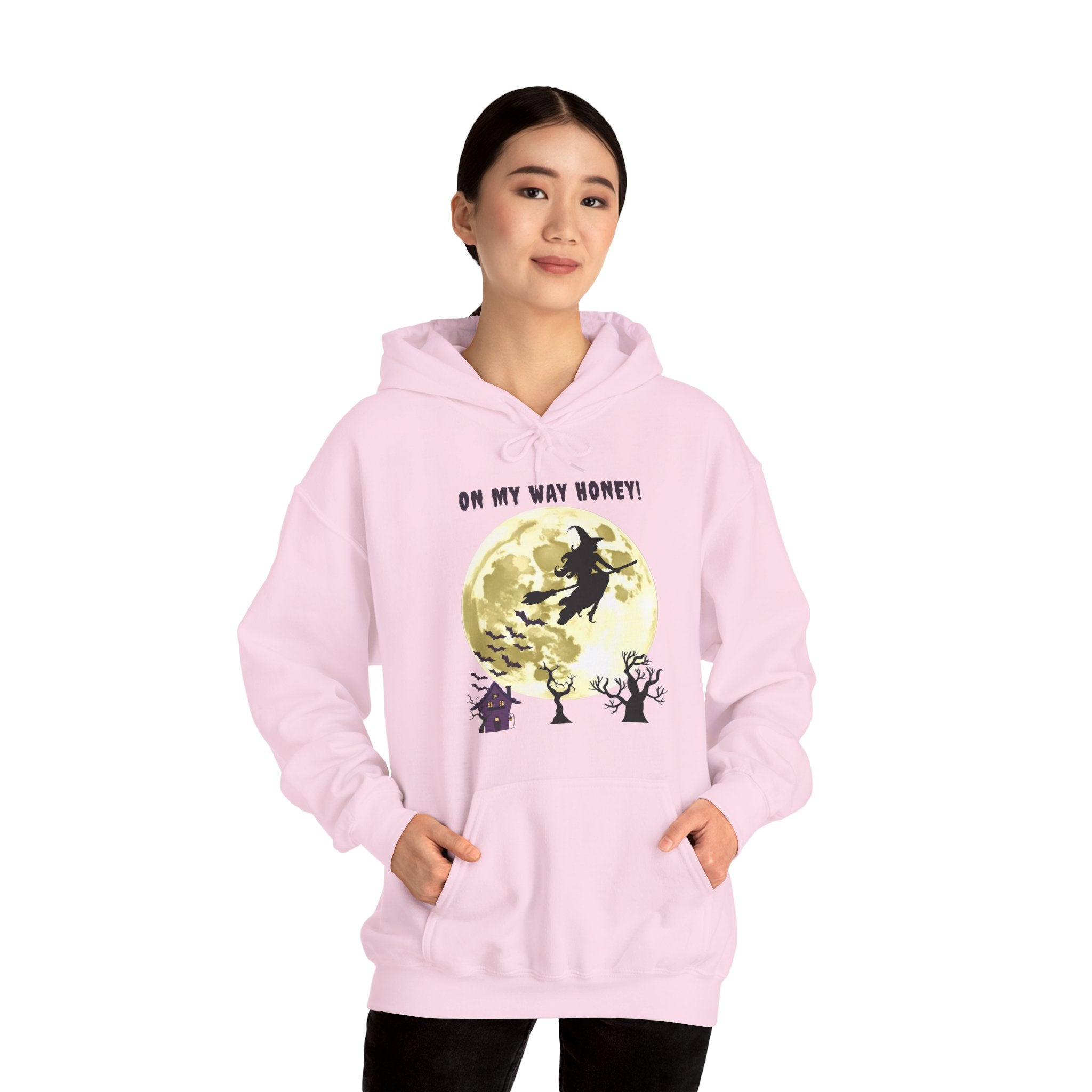 Person wearing a pink hoodie with a graphic design on a white background