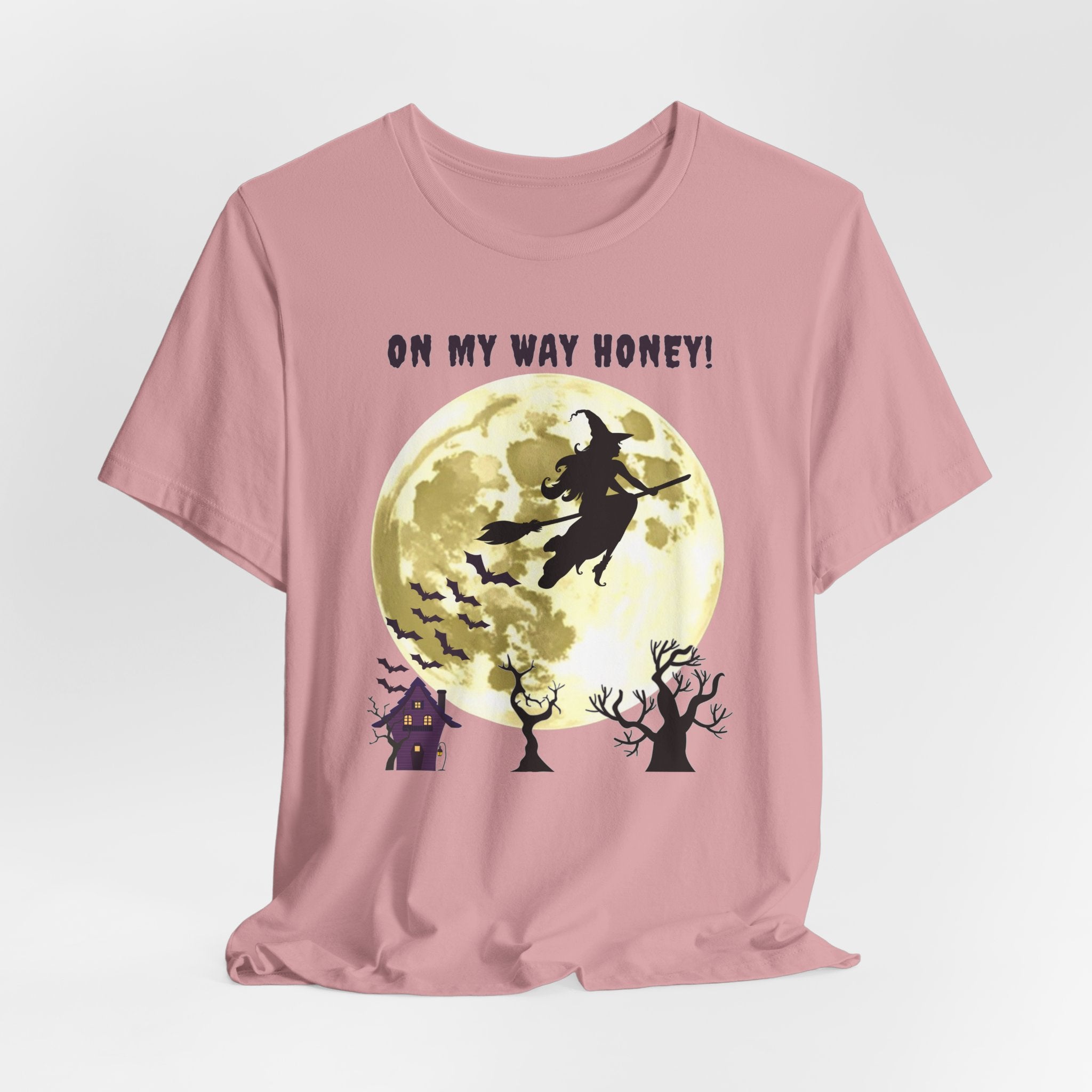 Orchid pink t-shirt with Halloween design featuring a witch, moon, and text 'On My Way Honey!' on a light gray background.
