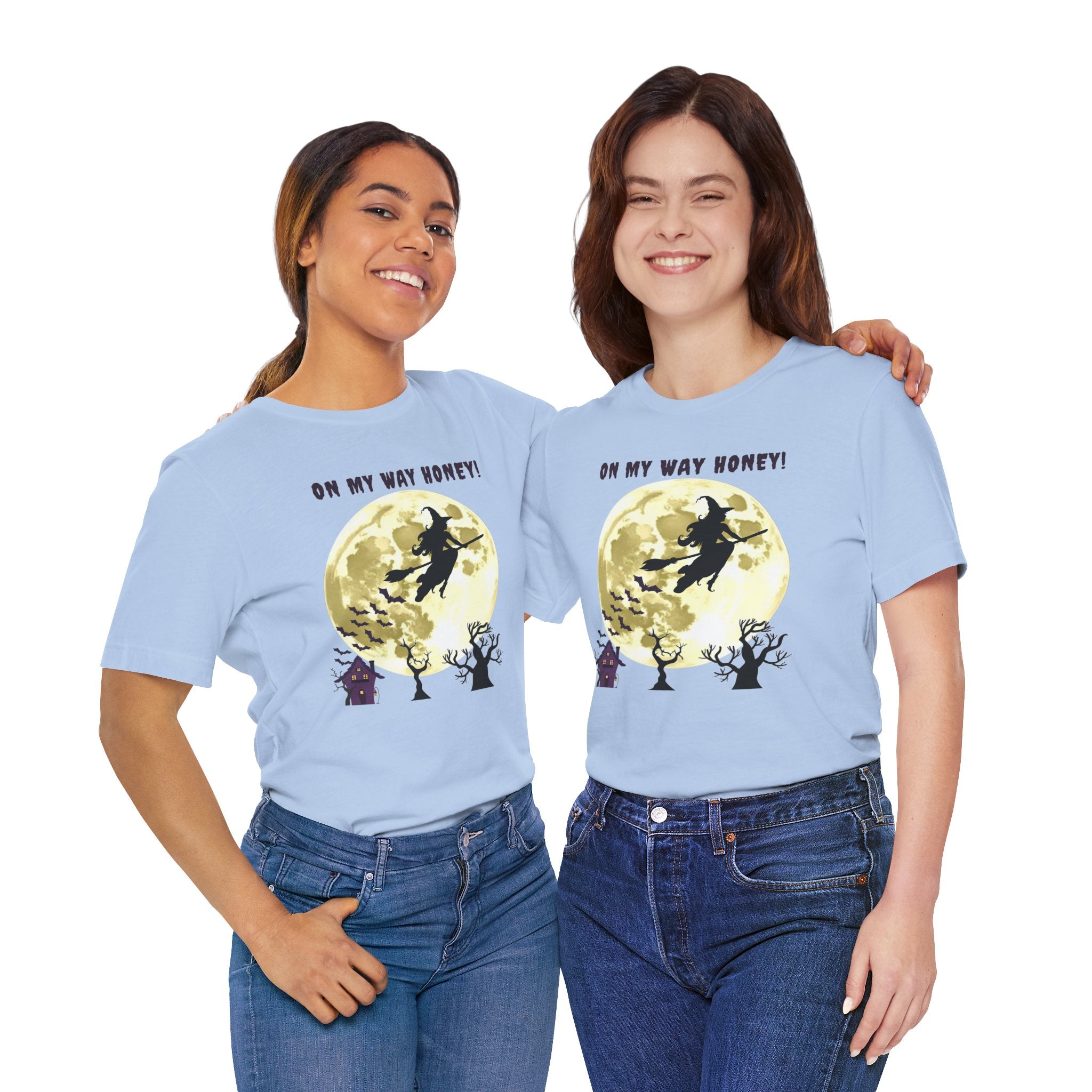 Two people wearing light blue t-shirts with a witch graphic and text on a white background