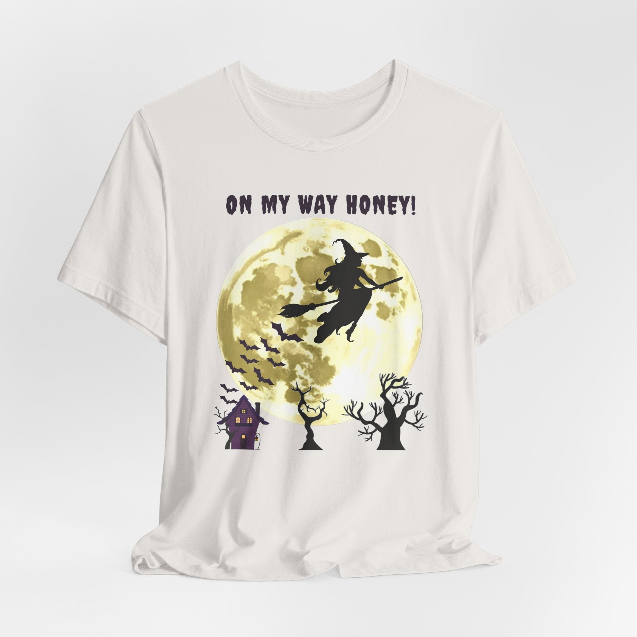 Vintage white t-shirt with Halloween-themed design featuring a witch, moon, and text 'On My Way Honey!' on a white background.