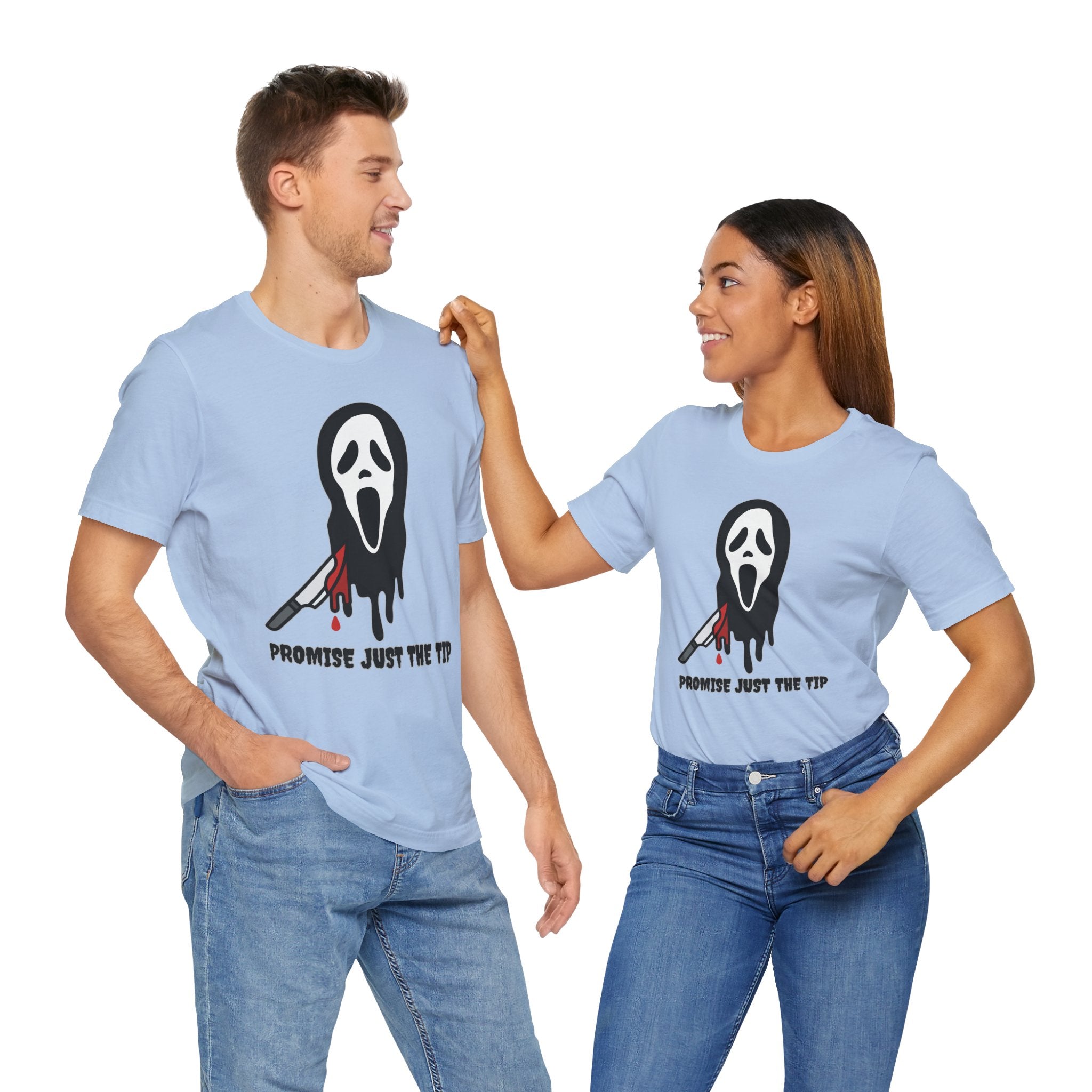 Two people wearing light blue t-shirts with a graphic design and text.