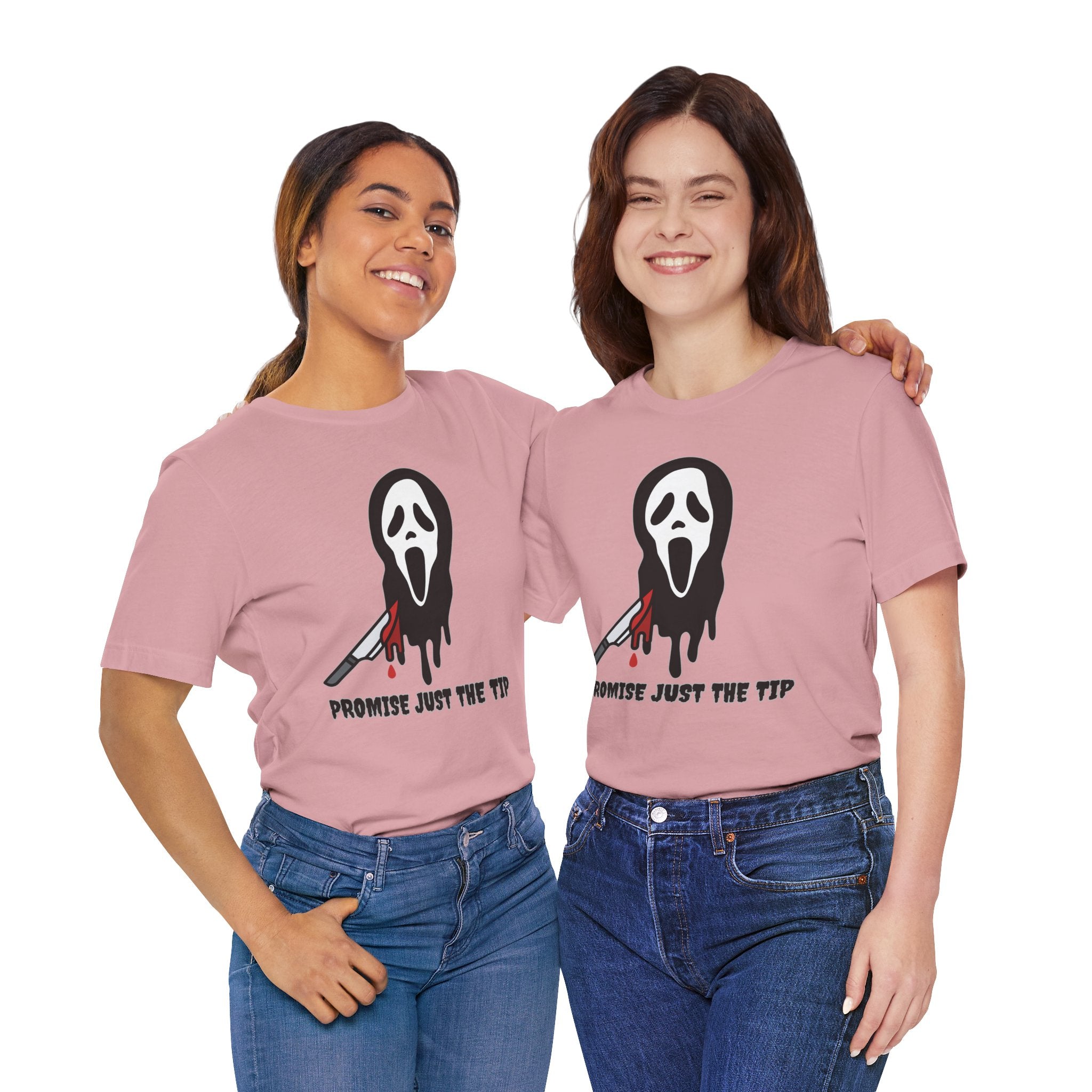Two people wearing pink t-shirts with a graphic design and text.