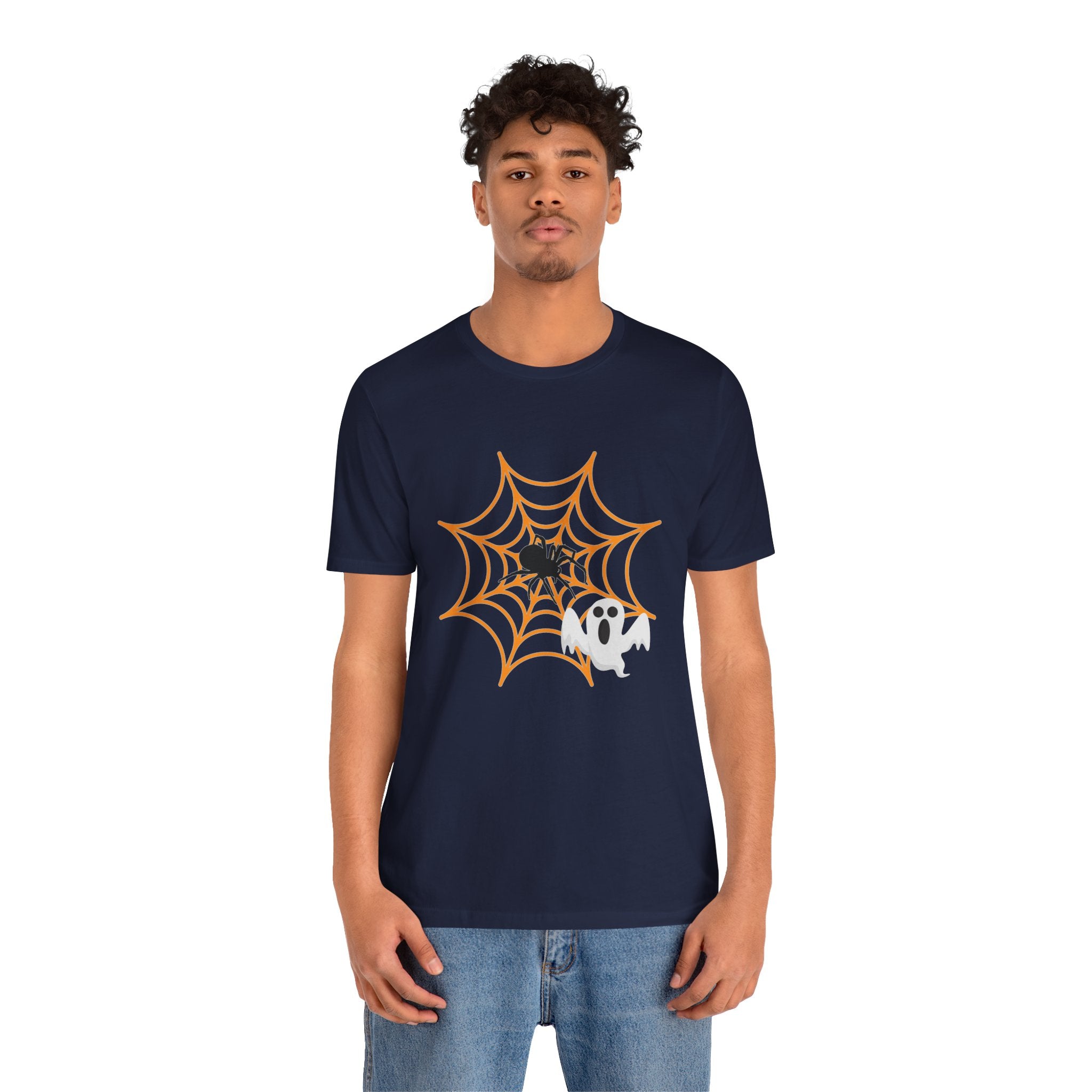 Person wearing a navy blue t-shirt with a spider web and ghost graphic on a white background