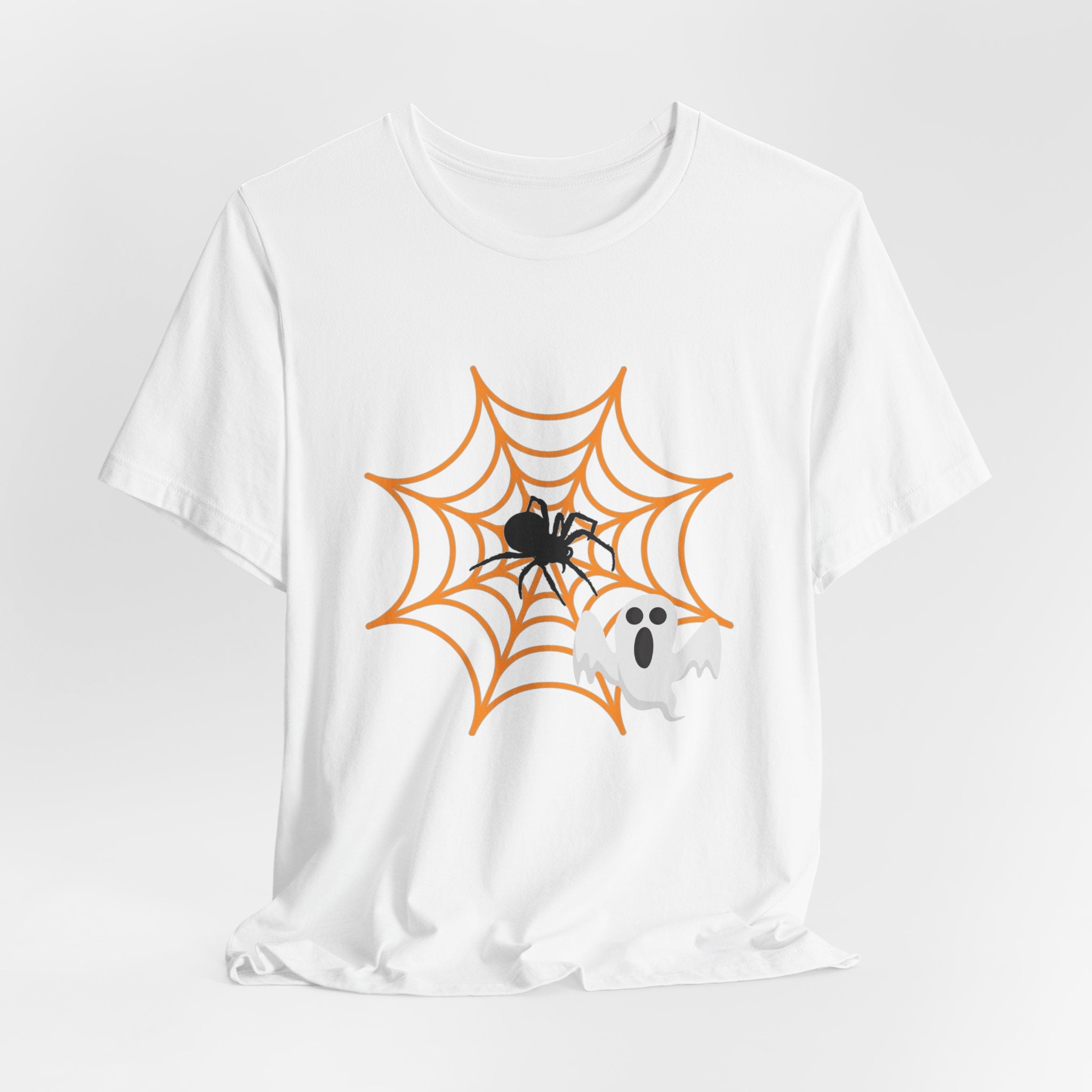 White t-shirt with Halloween design of a spider, spider web, and ghost on a white background