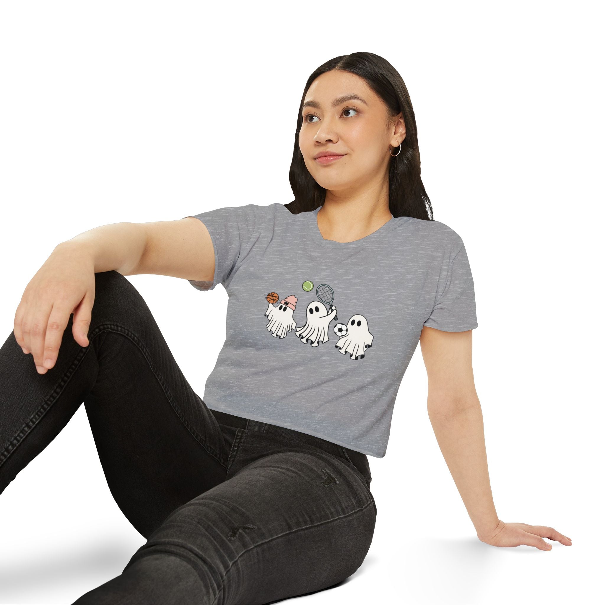 Woman wearing a gray t-shirt with cartoon ghosts design on a white background