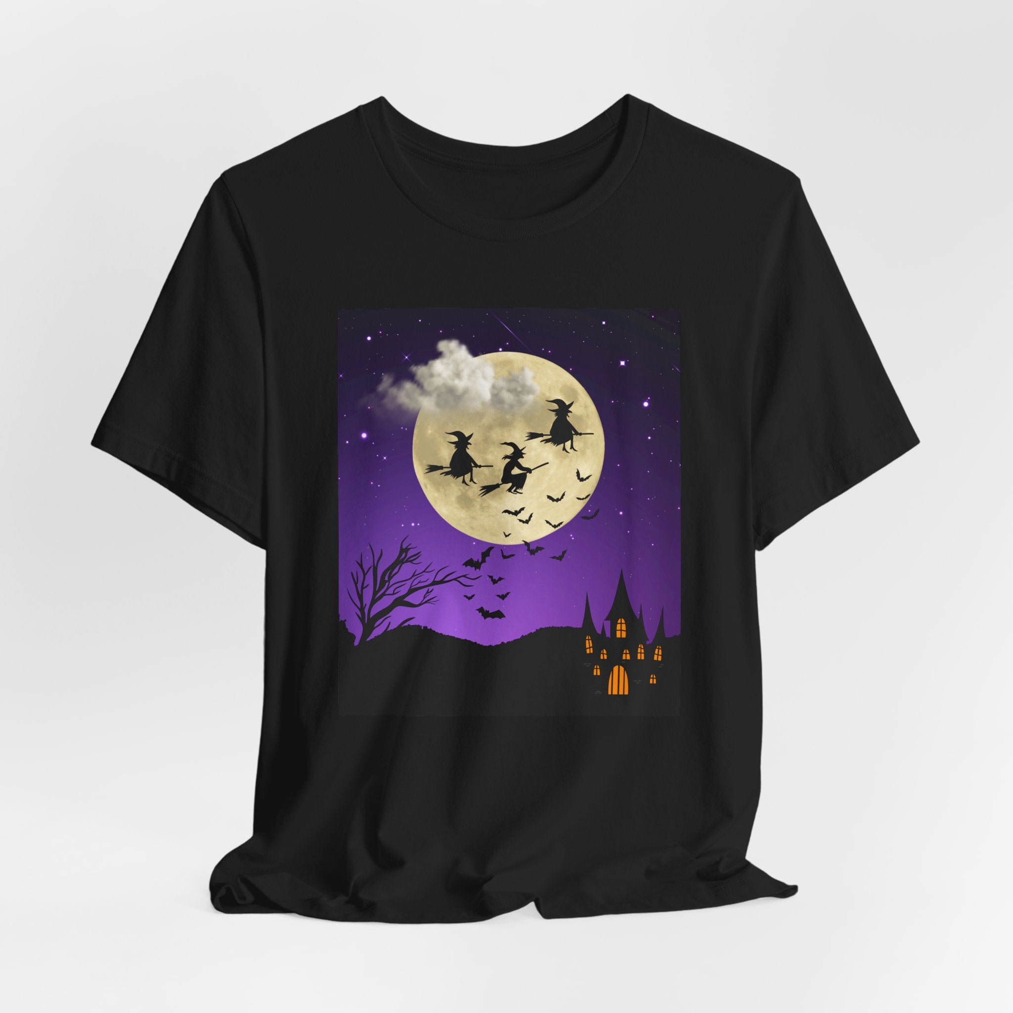 Black t-shirt with Halloween-themed design featuring witches on brooms, a full moon, and a castle.
