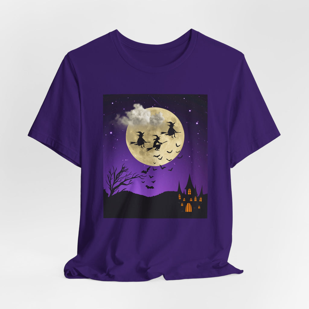 Purple t-shirt with Halloween-themed design featuring witches flying over a moonlit sky.