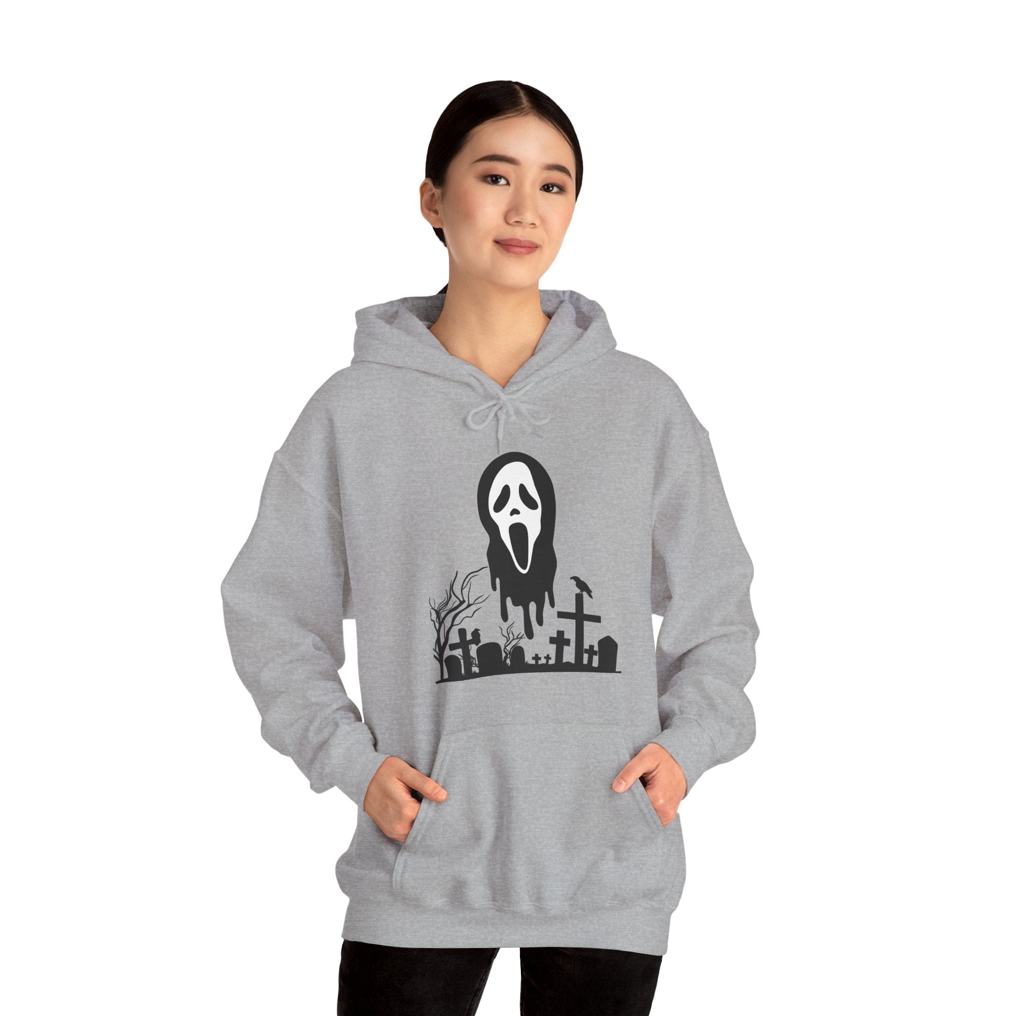 Person wearing a gray hoodie with a graphic design on a white background