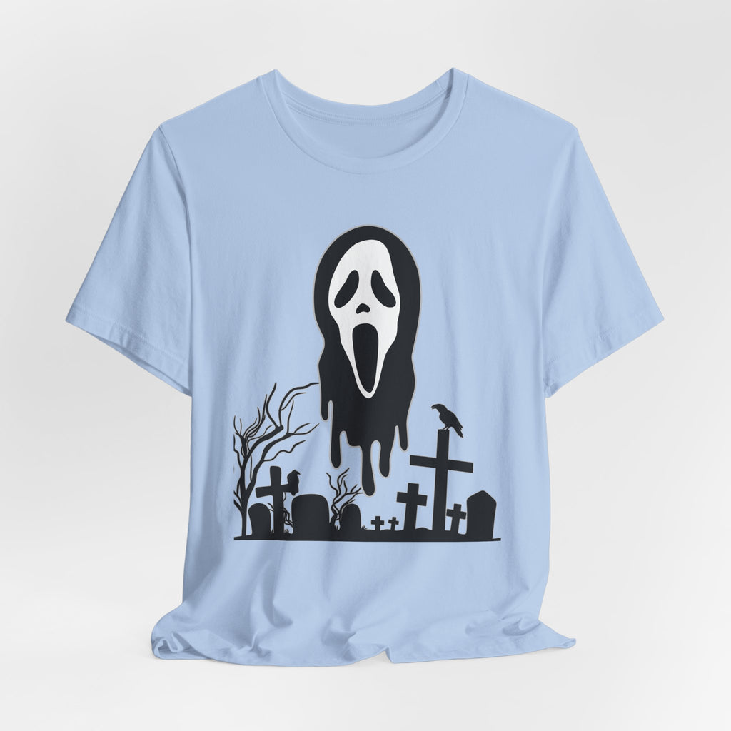 Light blue t-shirt with a Halloween-themed graphic of a ghost face and graveyard on a white background