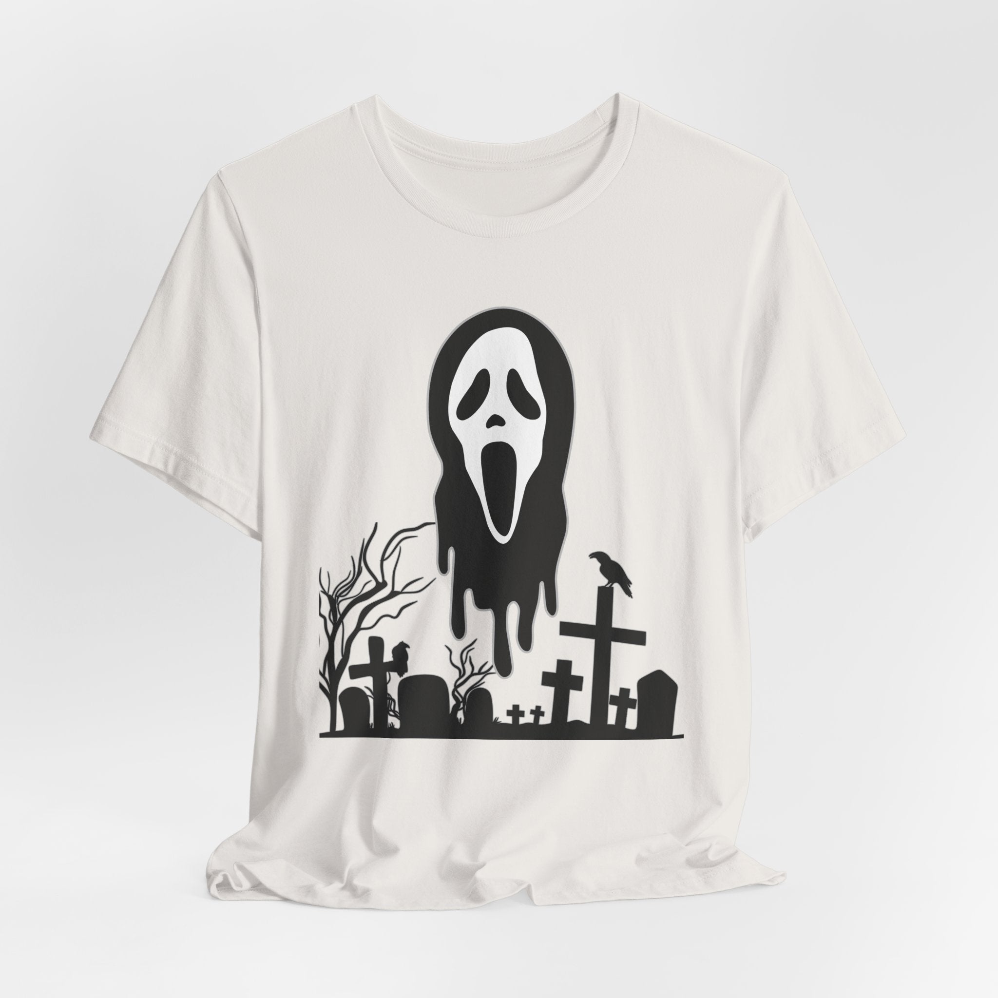 Vintage white t-shirt with black graphic design of a ghost face and graveyard on a white background