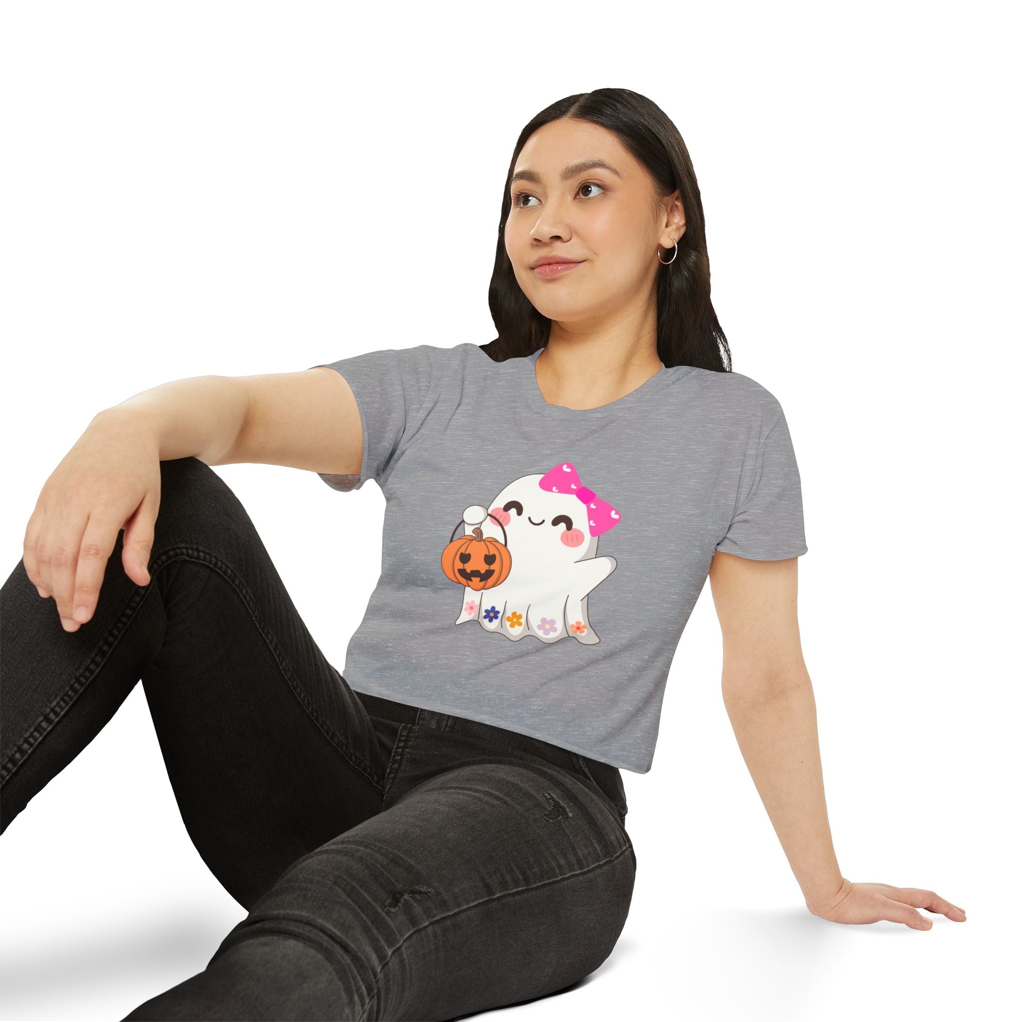 Woman wearing a gray t-shirt with a ghost holding a pumpkin design on a white background