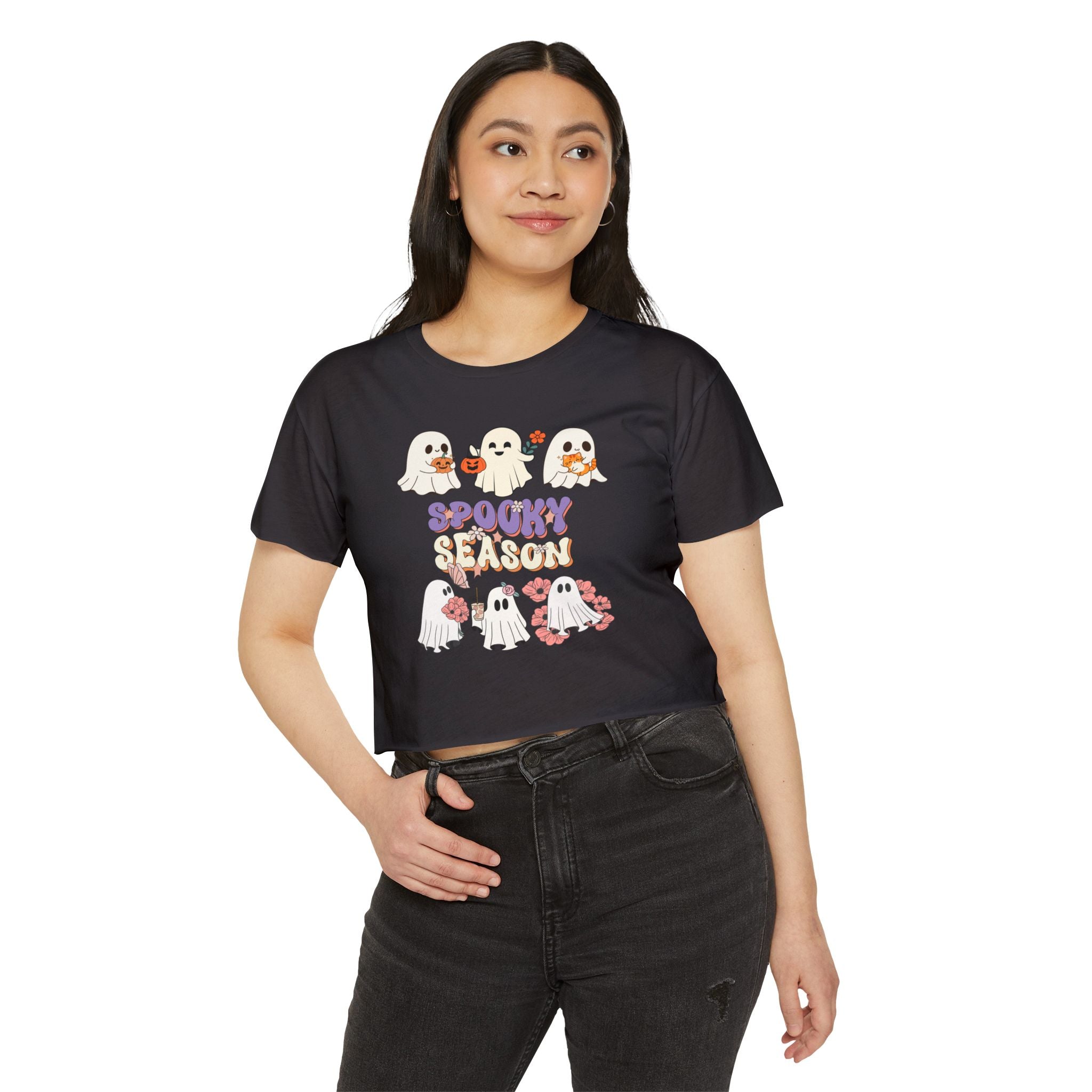 Woman wearing a black t-shirt with ghost graphics and 'Spooky Season' text on a white background