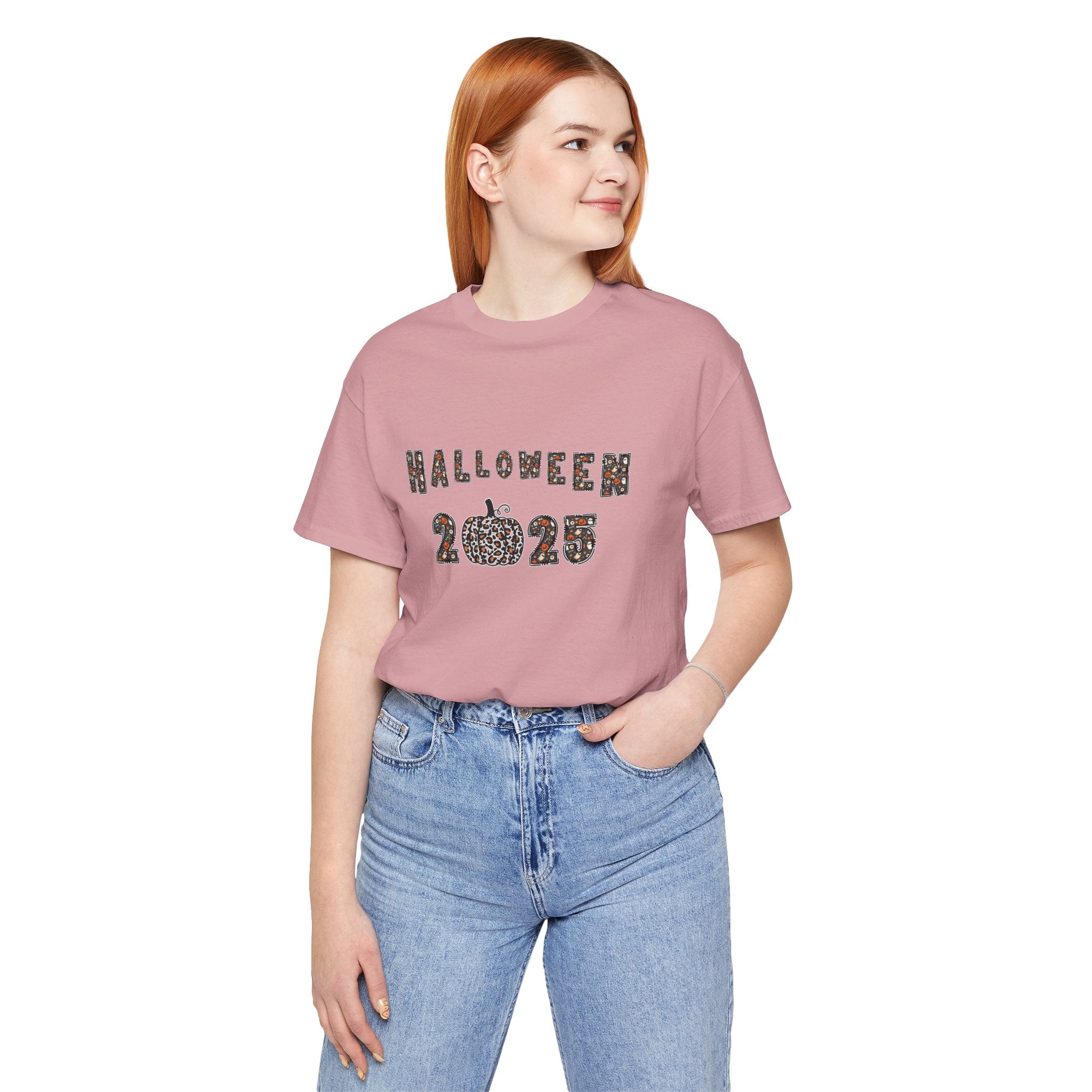 Person wearing a pink t-shirt with 'HALLOWEEN 2023' text and blue jeans on a white background