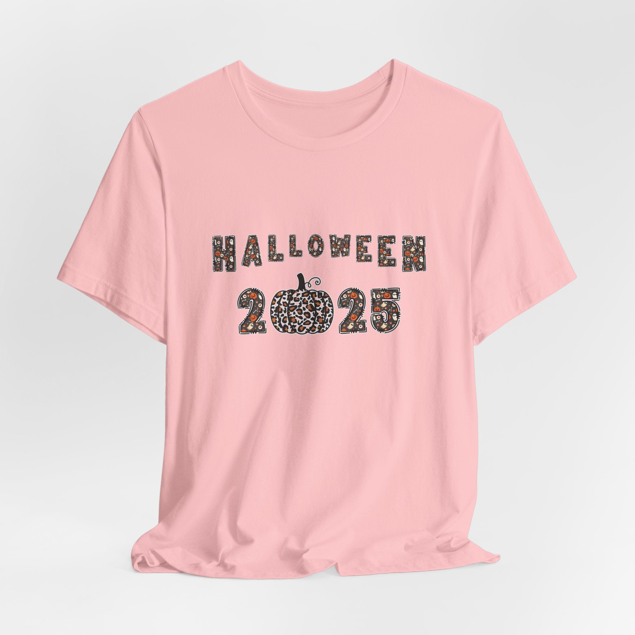 Pink t-shirt with 'Halloween 2025' design and spooky themes on a white background