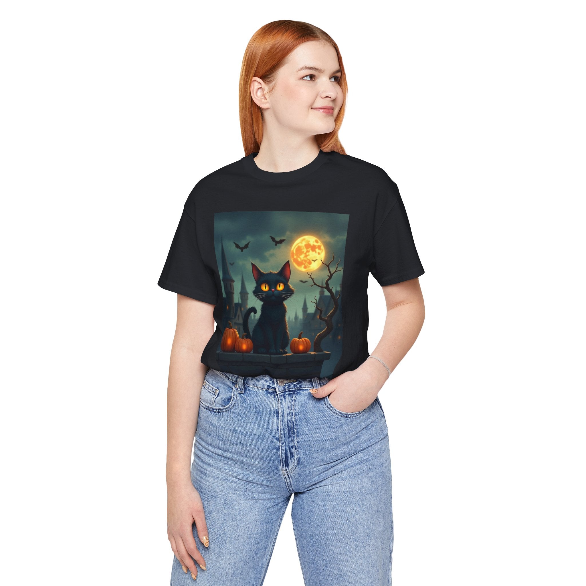 Person wearing a black t-shirt with a graphic of a black cat, moon, and pumpkins.