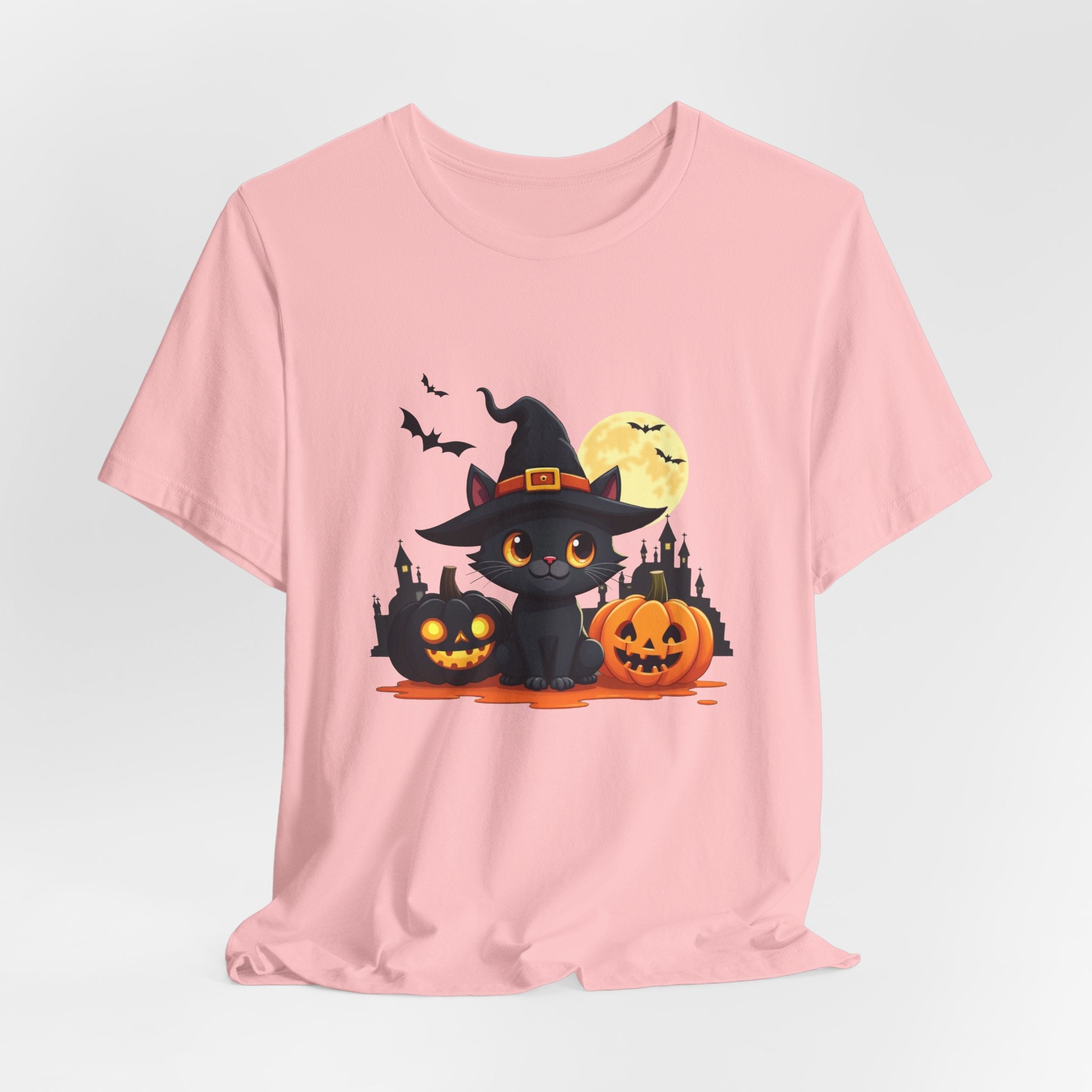 Pink t-shirt with Halloween-themed design featuring a black cat in a witch hat and pumpkins on a light gray background.