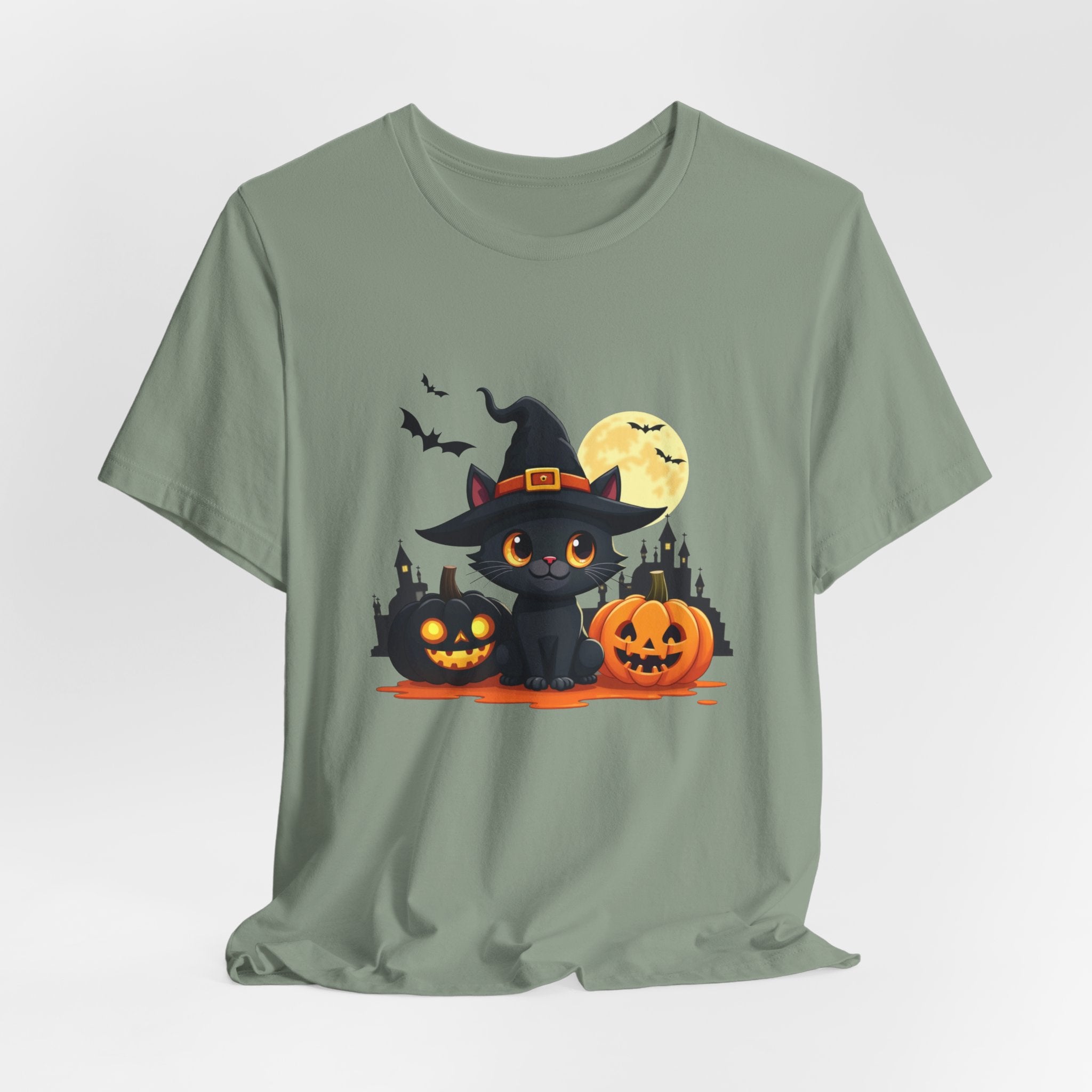 Sage green t-shirt with Halloween-themed design featuring a black cat in a witch hat, pumpkins, and a moon.