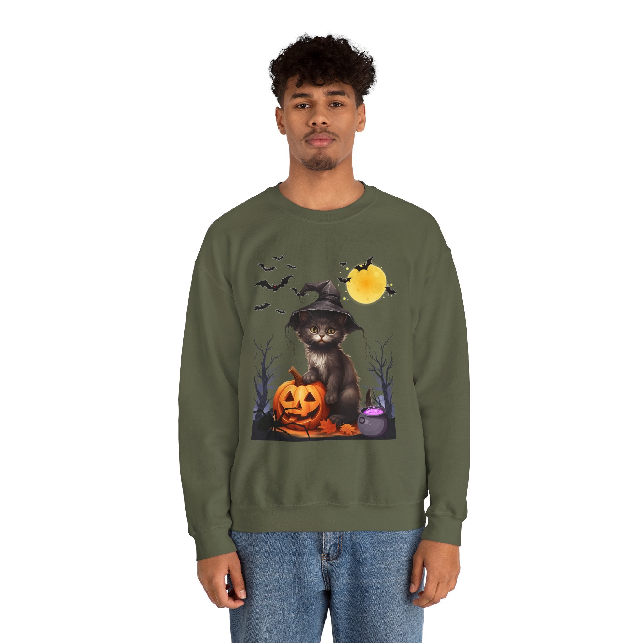 Person wearing a green sweatshirt with a Halloween-themed design featuring a cat in a witch hat, pumpkin, and bats.
