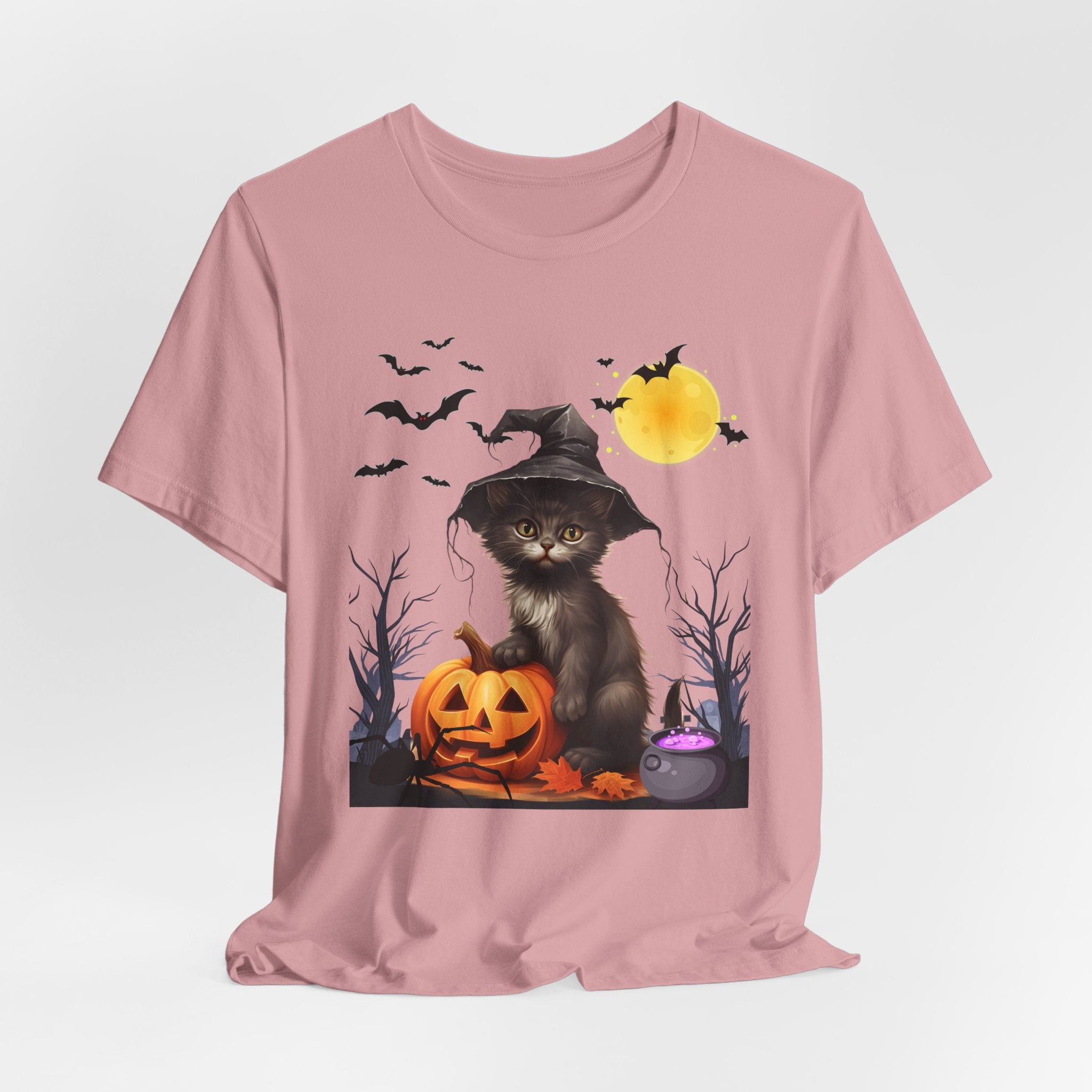 Orchid pink t-shirt with a Halloween-themed design featuring a cat in a witch hat, pumpkins, and bats on a white background.