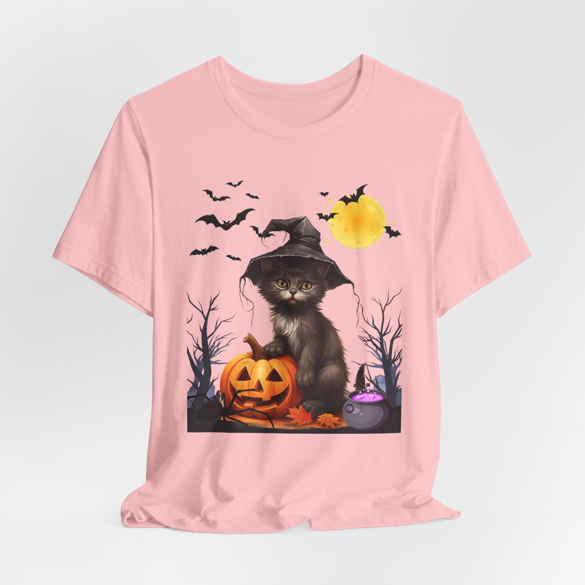 Pink t-shirt with a Halloween-themed design featuring a cat in a witch hat and pumpkin.