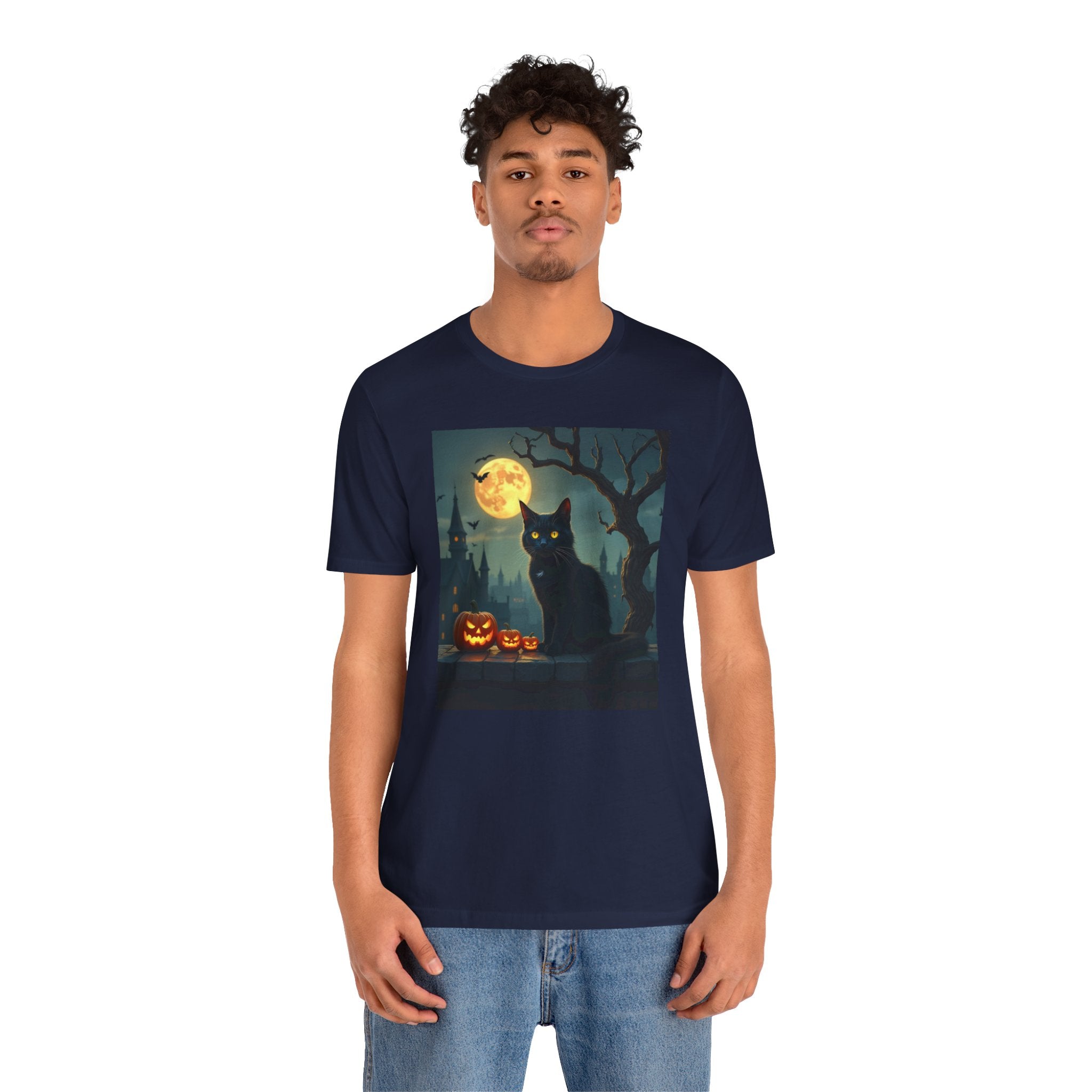 Person wearing a navy blue t-shirt with a Halloween design featuring a black cat and pumpkins.