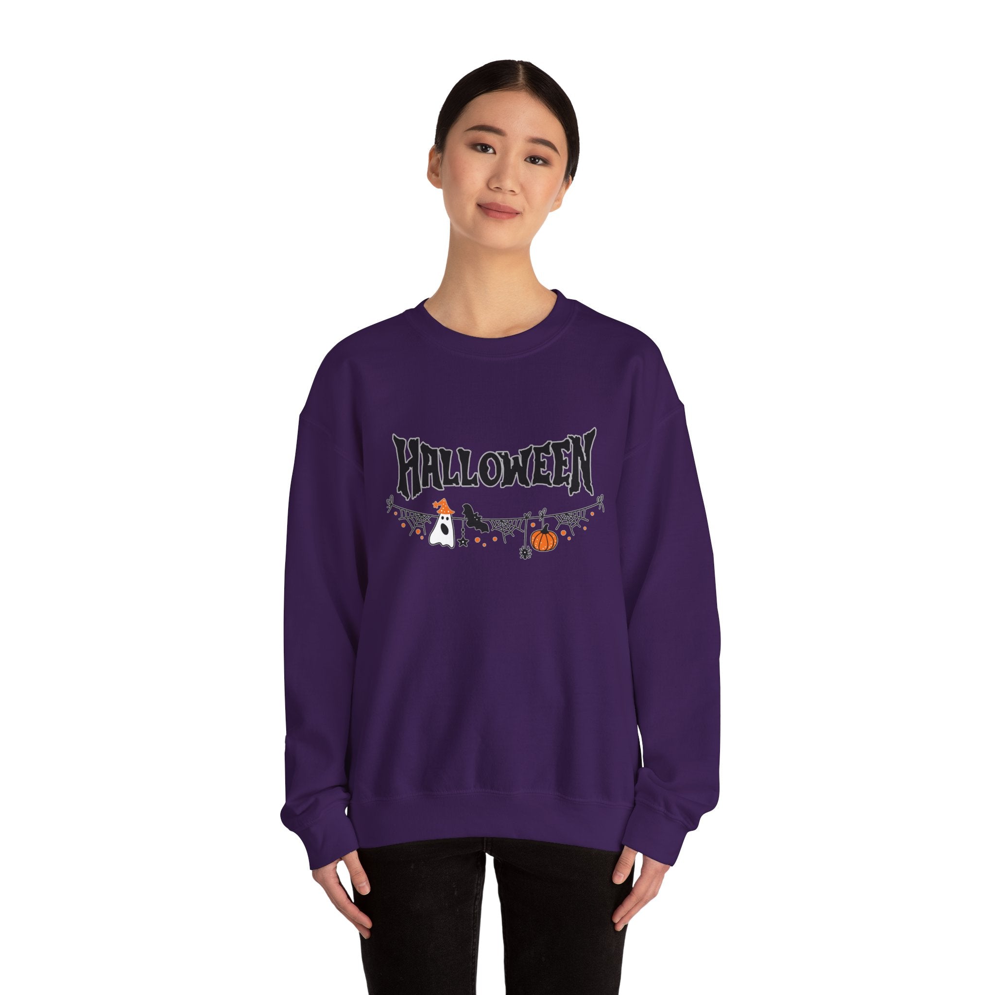Person wearing a purple 'Halloween' themed sweatshirt on a white background