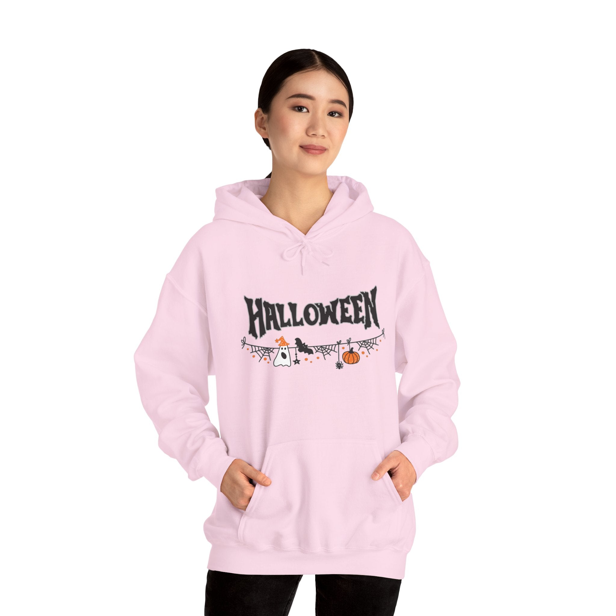 Person wearing a pink hoodie with Halloween-themed design on a white background