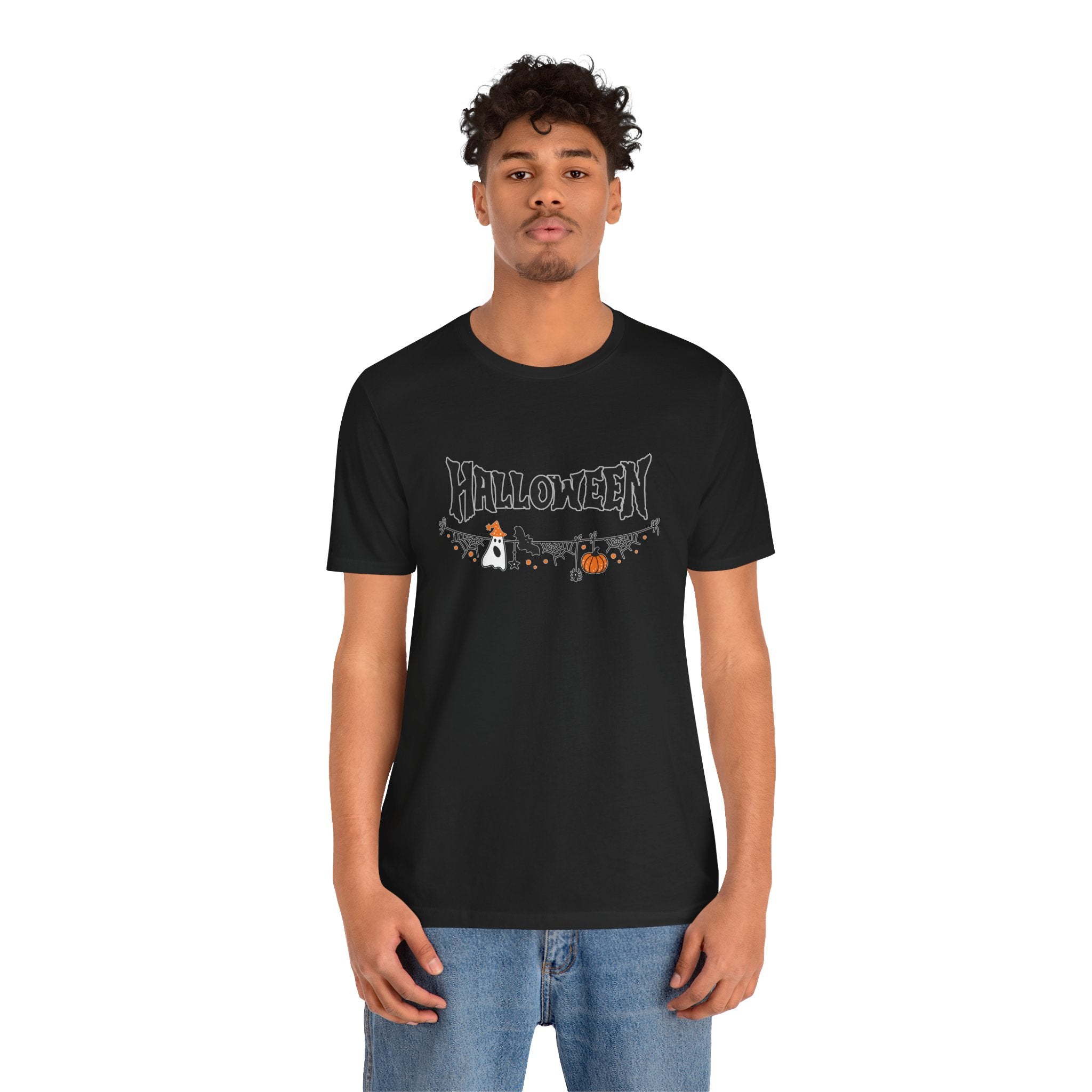 Person wearing a black t-shirt with Halloween design on a white background