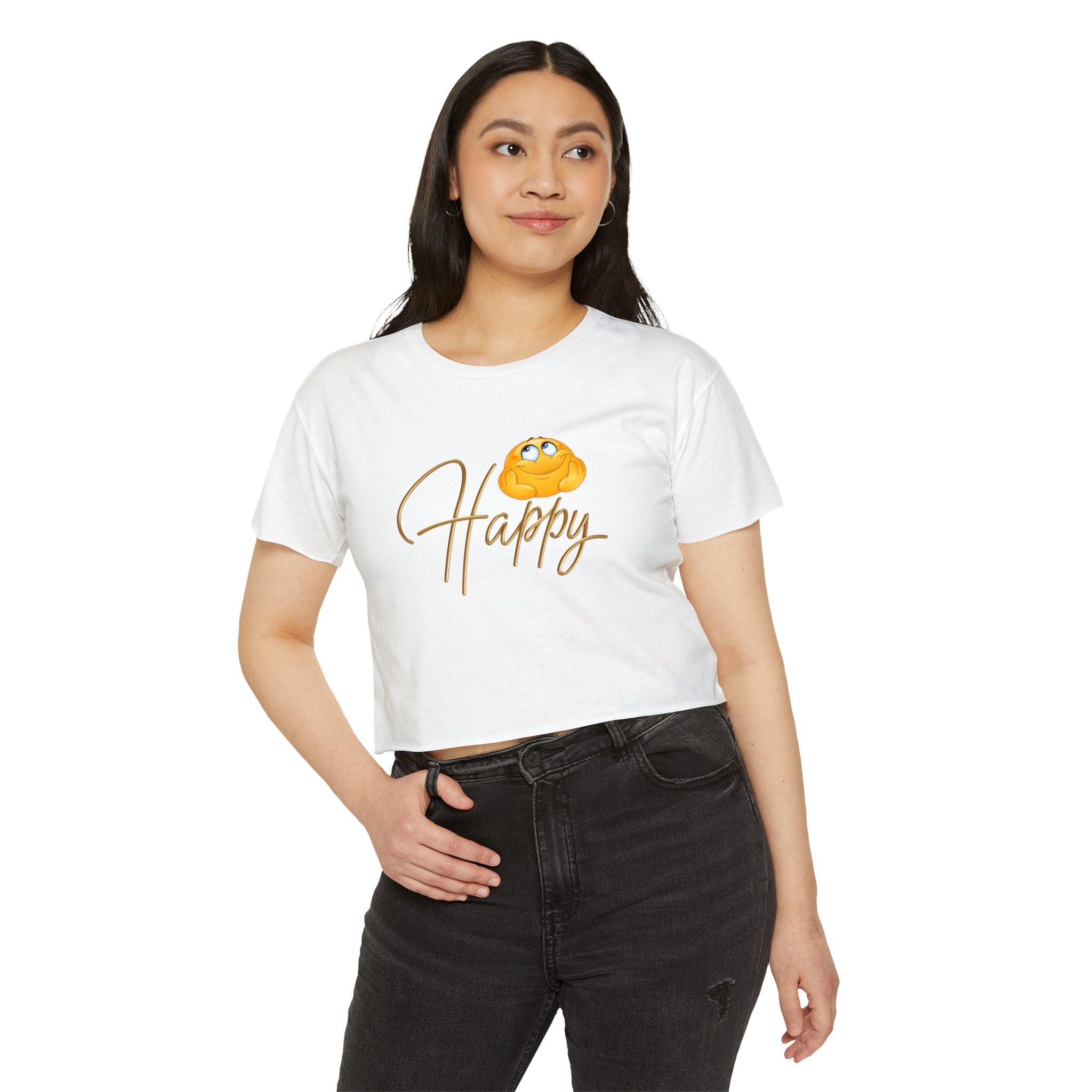 Woman wearing a white crop top t-shirt with a graphic design of happy emoji, standing on a white background.