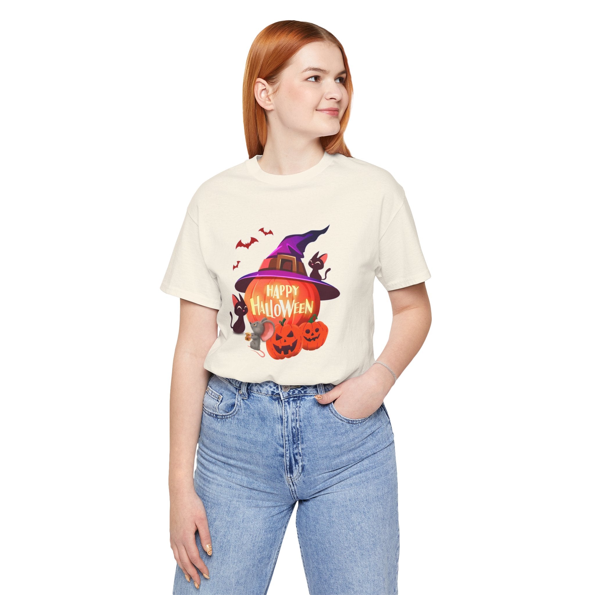 Person wearing a Halloween-themed t-shirt with pumpkins and a witch hat on a white background