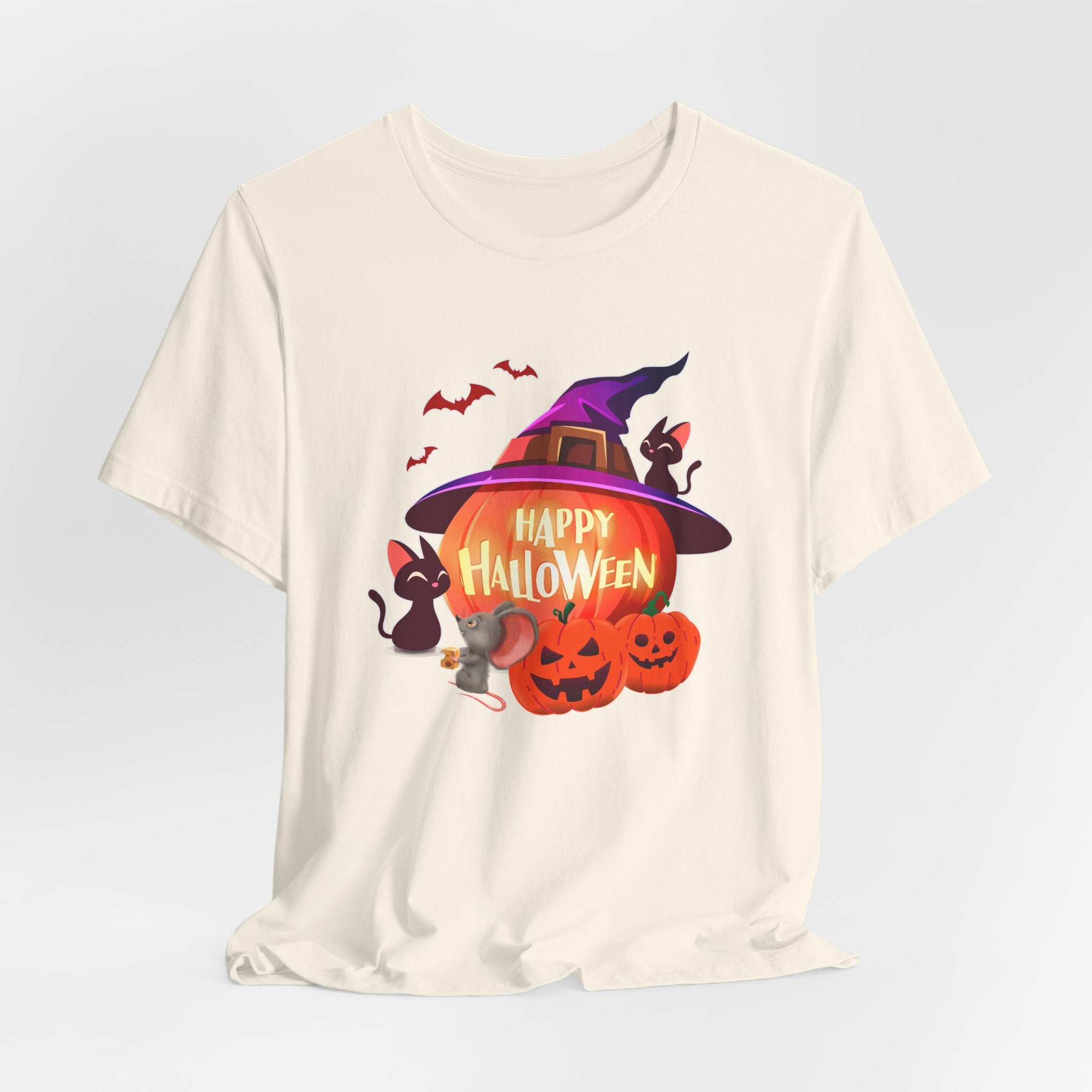 Ivory beige t-shirt with Halloween-themed design featuring pumpkins, bats, rodents, and a witch hat on a light gray edge background.