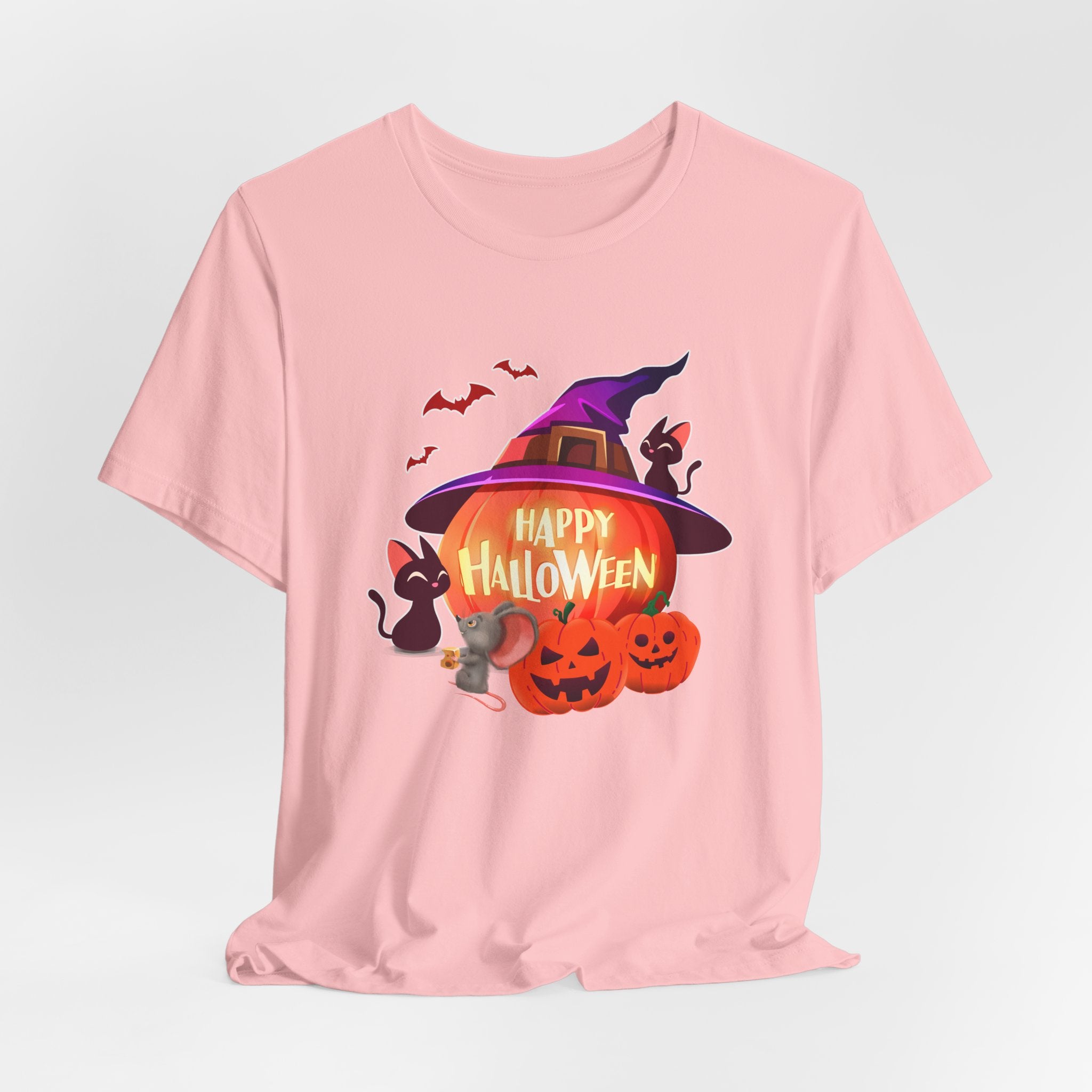 Pink t-shirt with Halloween-themed design featuring pumpkins, bats, rodents, and a witch hat on a light gray edge background.