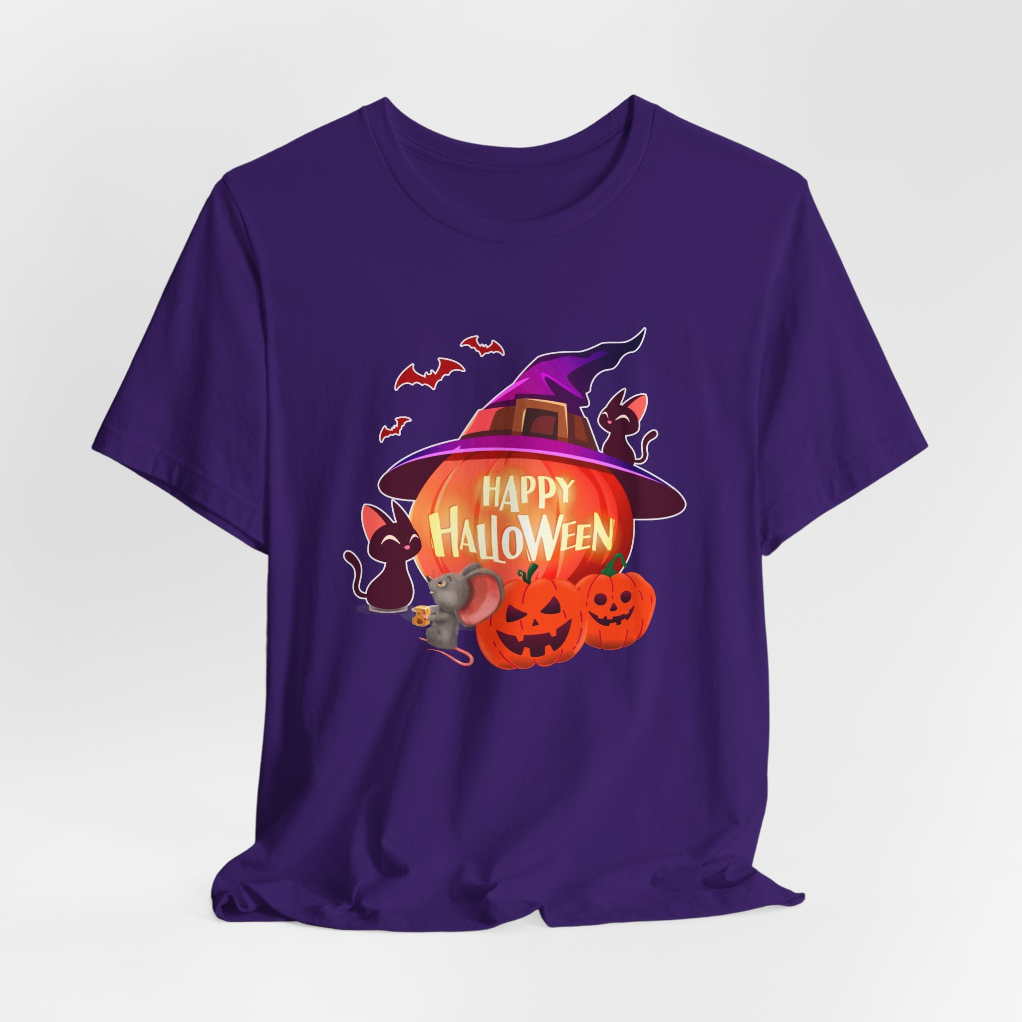 Team purple t-shirt with Halloween-themed design featuring pumpkins, bats, rodents, and a witch hat on a light gray edge background.