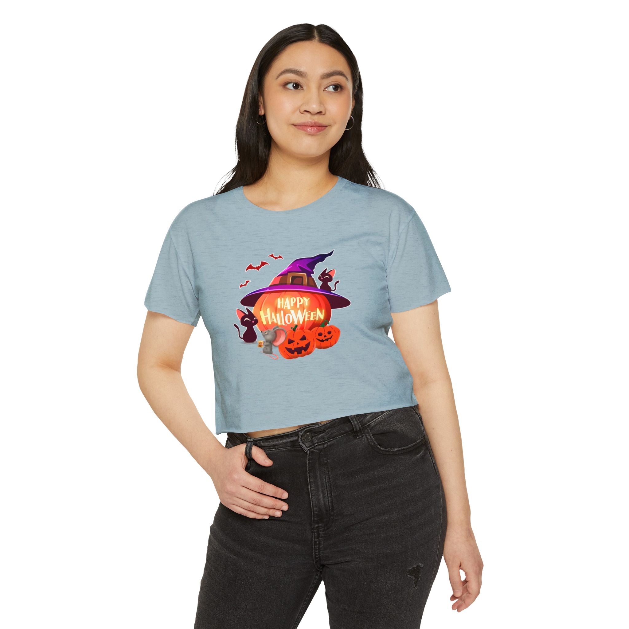 A standing woman wearing stonewash denim crop top shirt printed in halloween theme. 