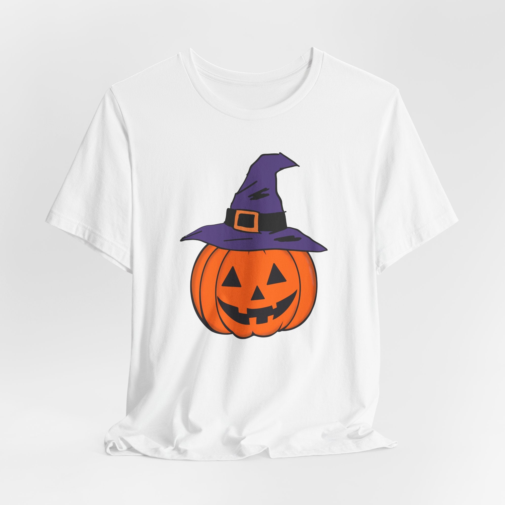 White t-shirt with a Halloween pumpkin graphic wearing a purple witch hat on a white background
