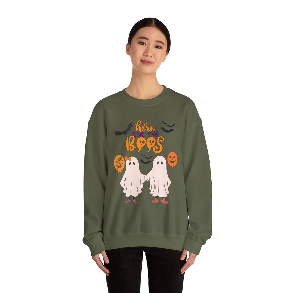Person wearing a green Halloween-themed sweatshirt with ghosts and text on a white background