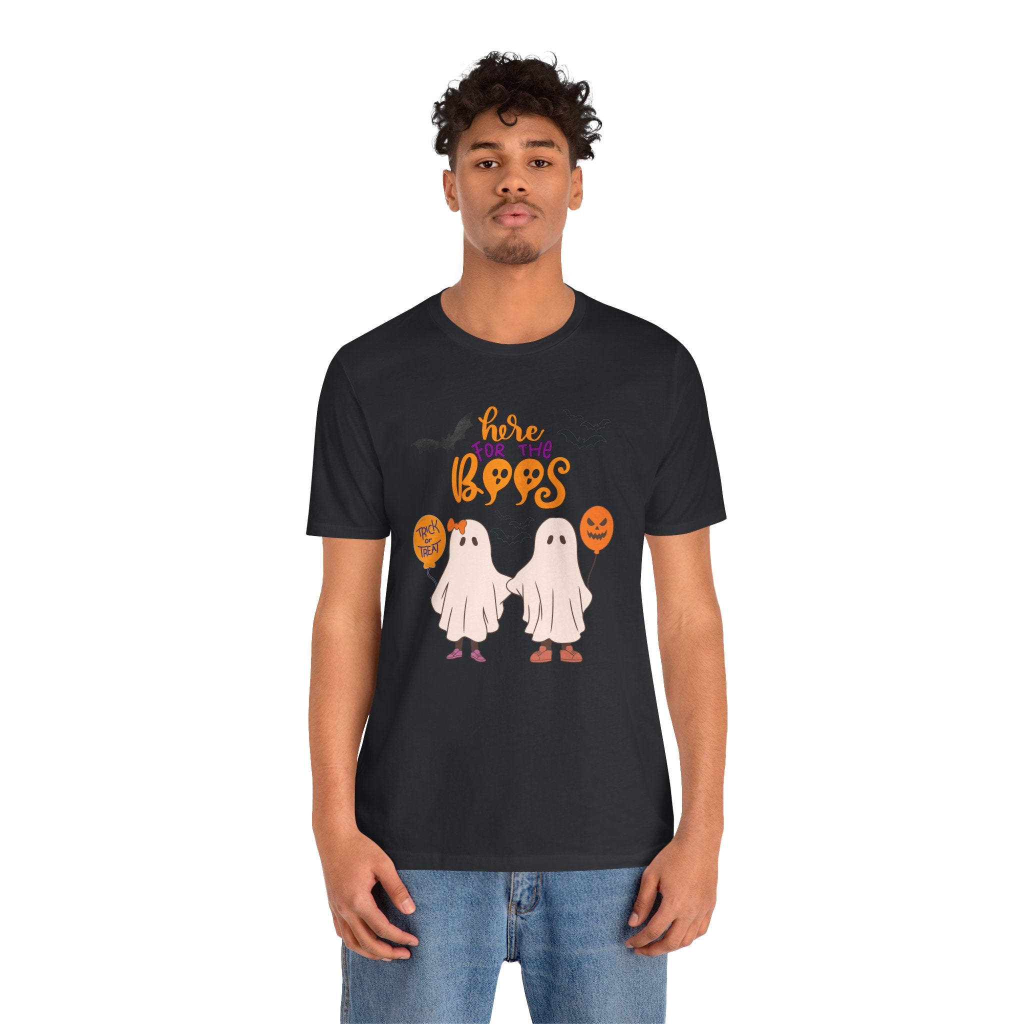 Person wearing a black t-shirt with Halloween-themed design on a white background