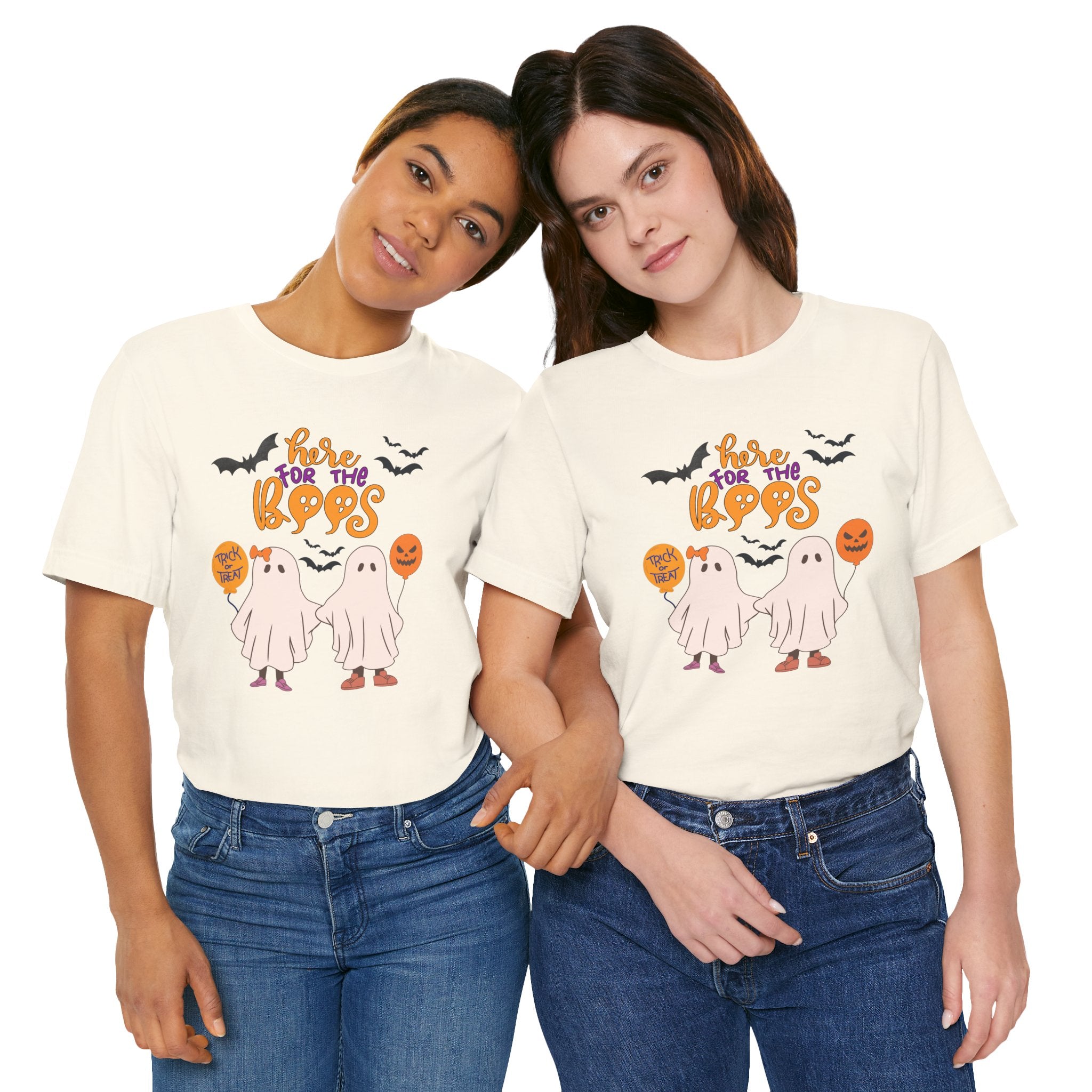 Two people wearing cream t-shirts with Halloween-themed graphics on a white background