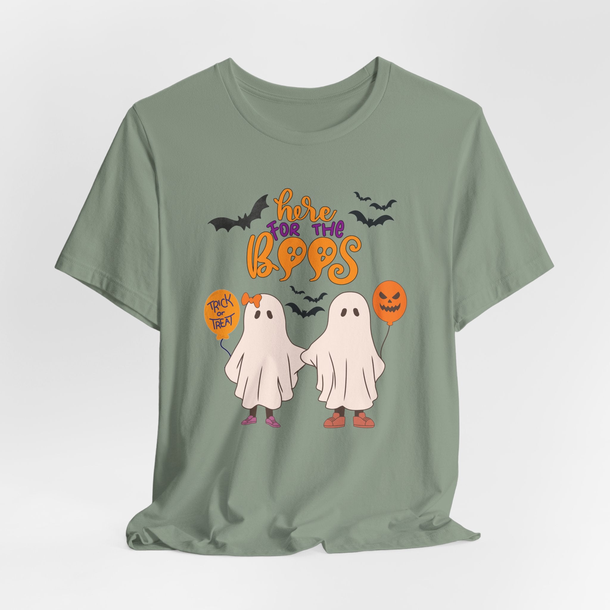 Sage green t-shirt with Halloween-themed graphics and text on a white background