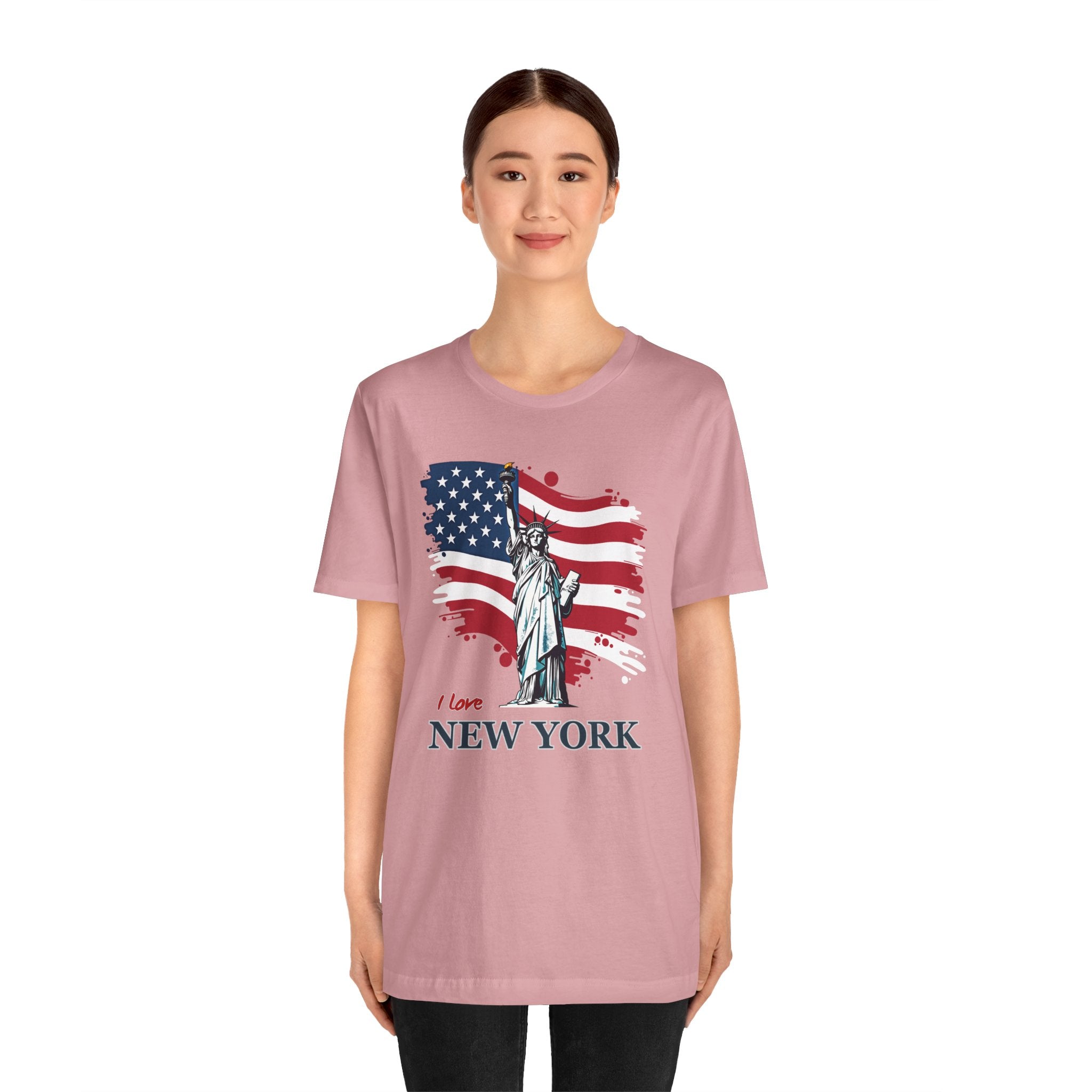 Person wearing a pink t-shirt with an American flag and Statue of Liberty design on a white background