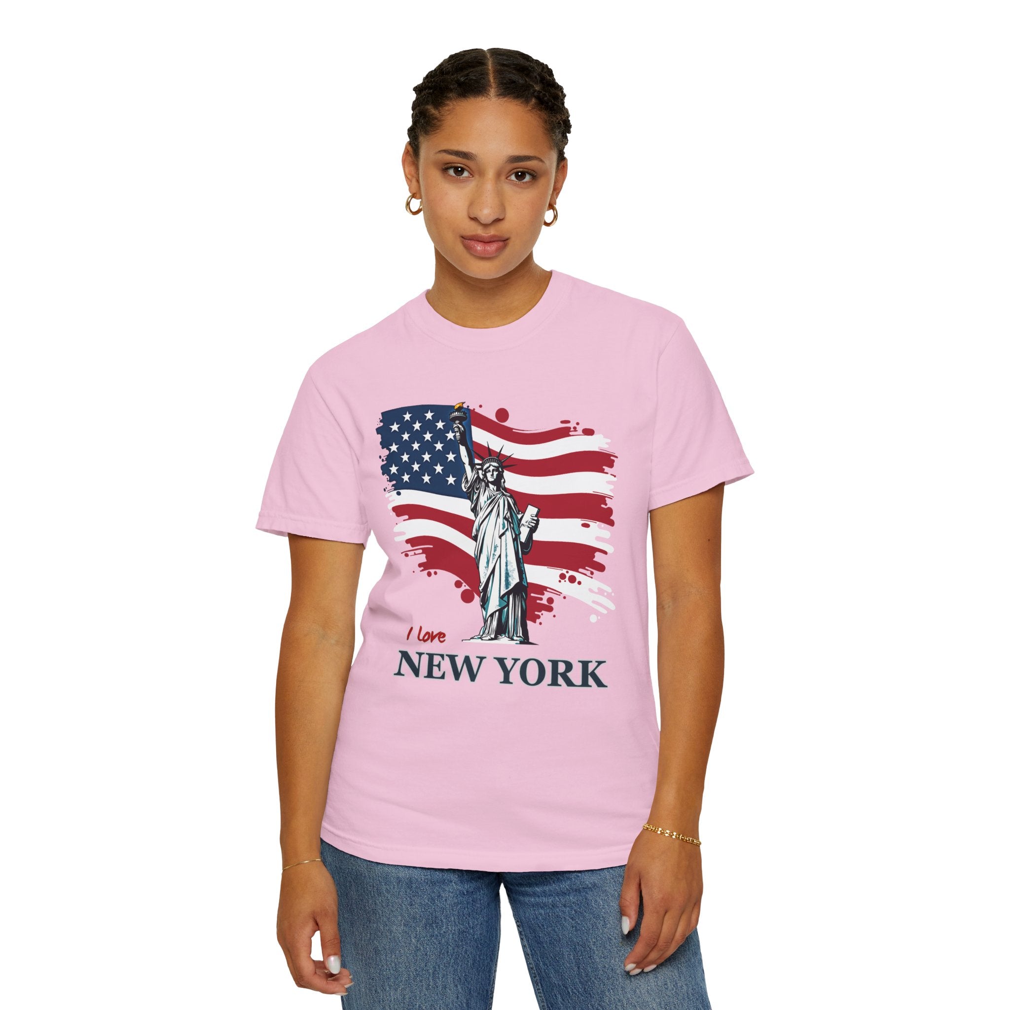 Person wearing a pink t-shirt with an American flag and Statue of Liberty design, text 'I love New York'.