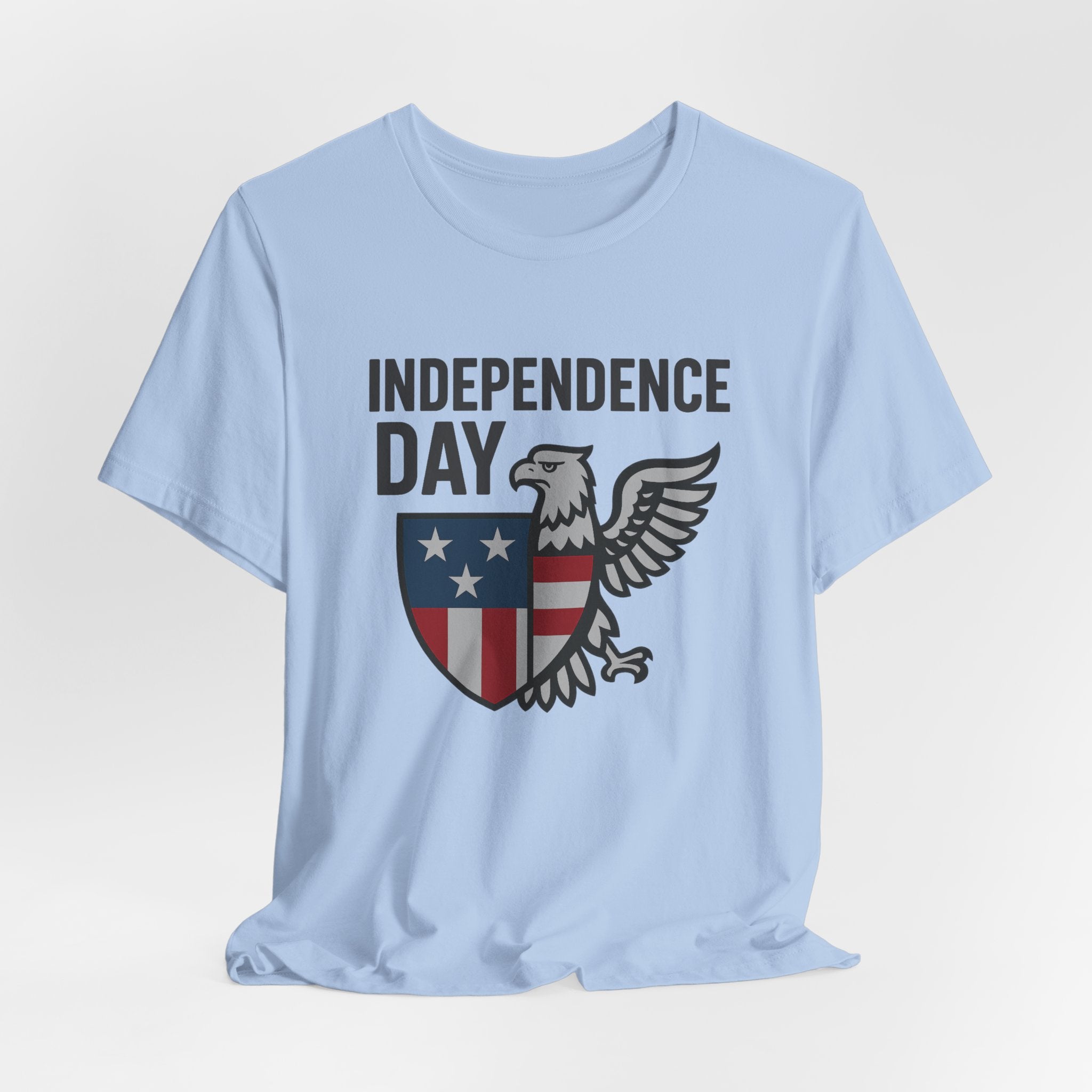 Light blue t-shirt with 'Independence Day' graphic featuring an eagle and shield on a white background