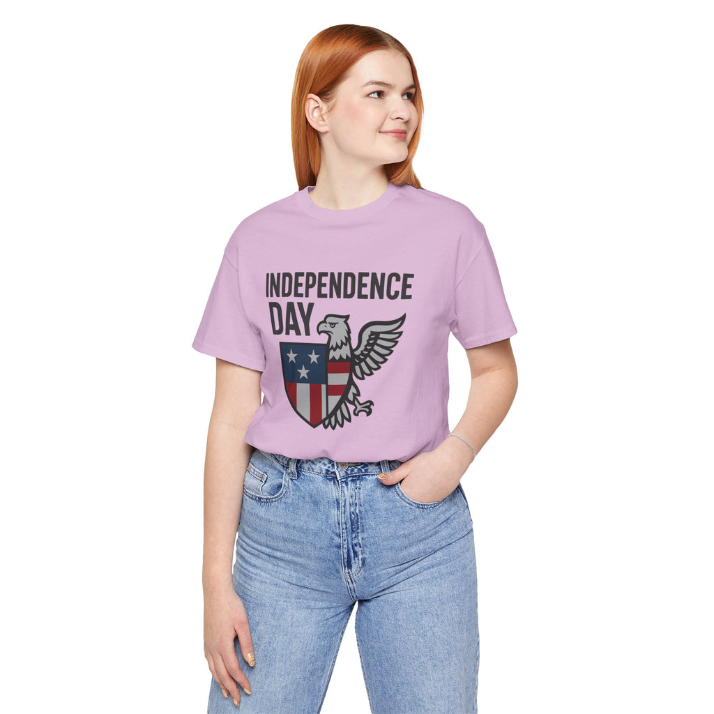 Person wearing a purple 'Independence Day' t-shirt with an eagle graphic on a white background