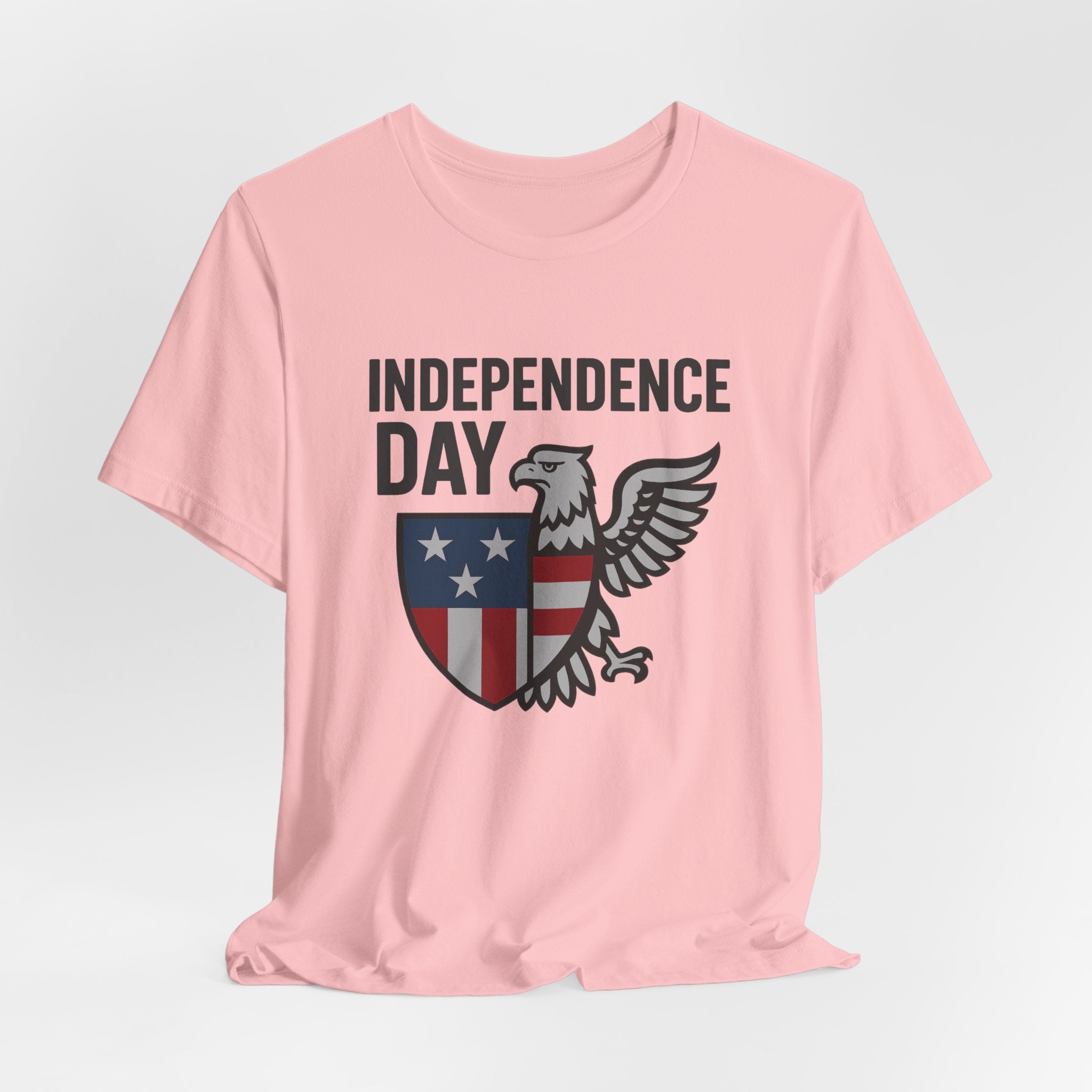 Pink t-shirt with 'Independence Day' graphic design on a light gray background