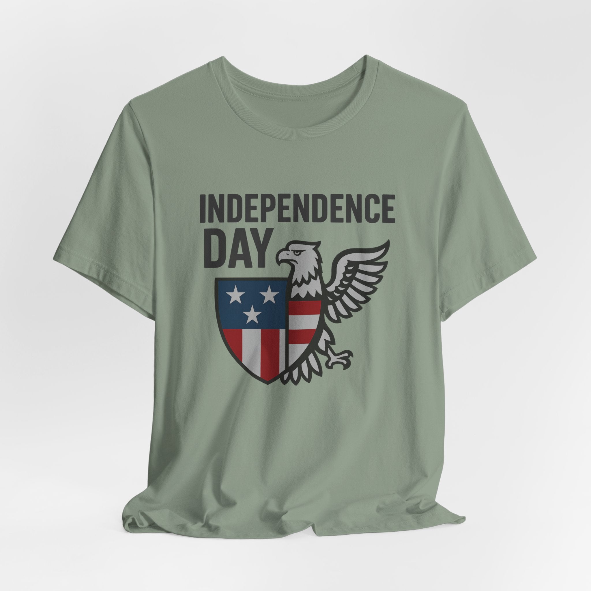 Sage green t-shirt with 'Independence Day' design featuring an eagle and shield on a white background