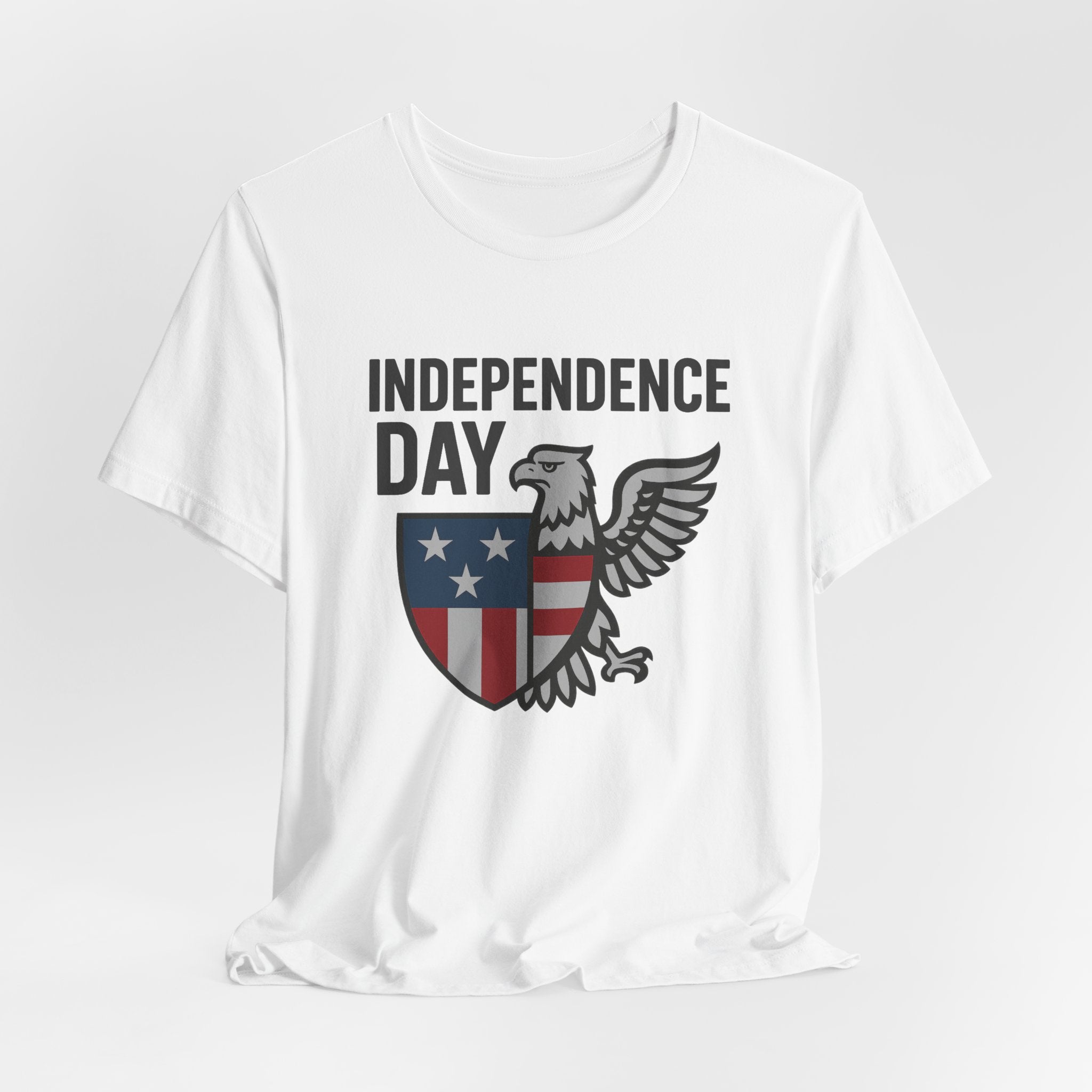 White t-shirt with 'Independence Day' graphic featuring an eagle and shield on a white background