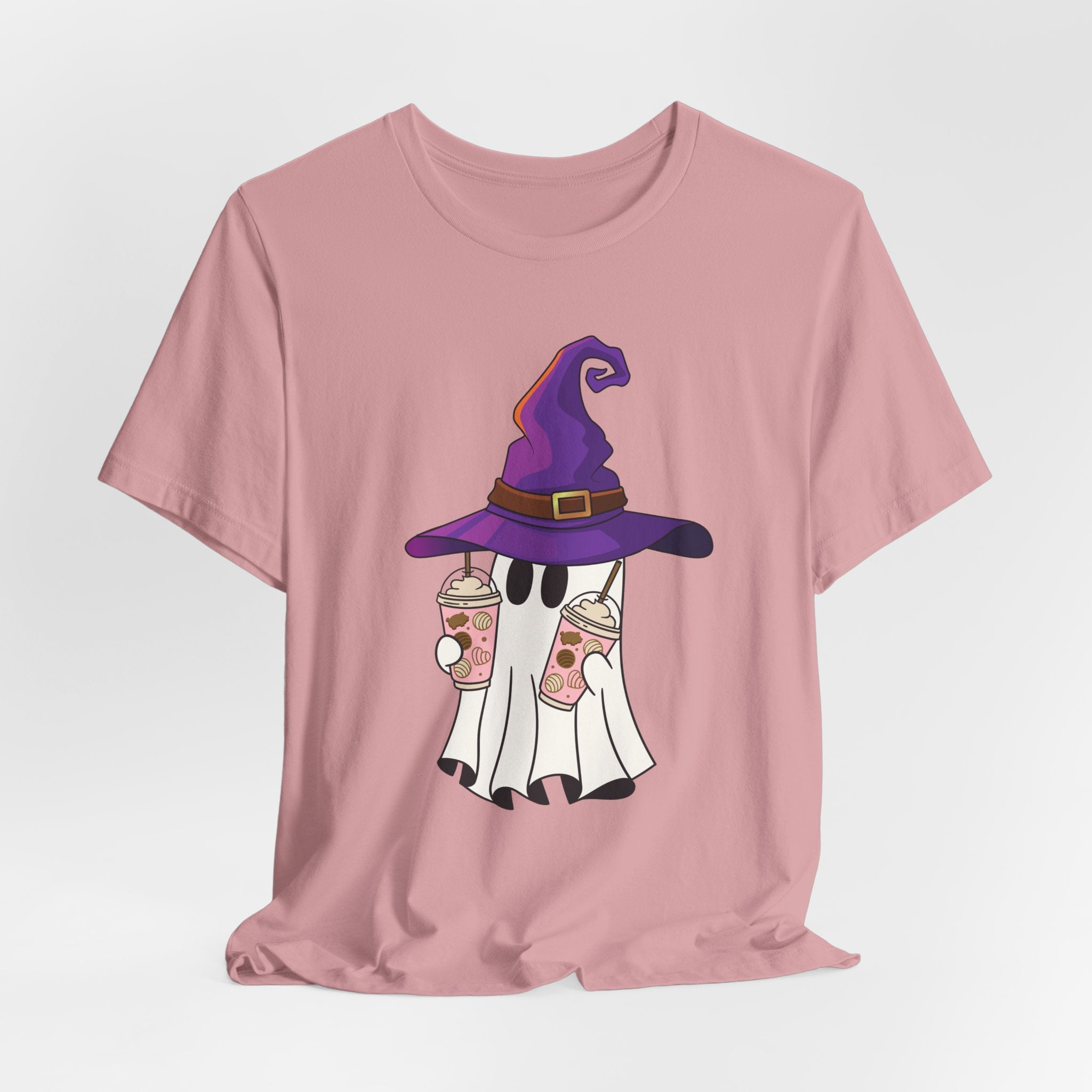 Orchid pink t-shirt with ghost and purple witch hat graphic holding two cups of  juice on a light gray background 