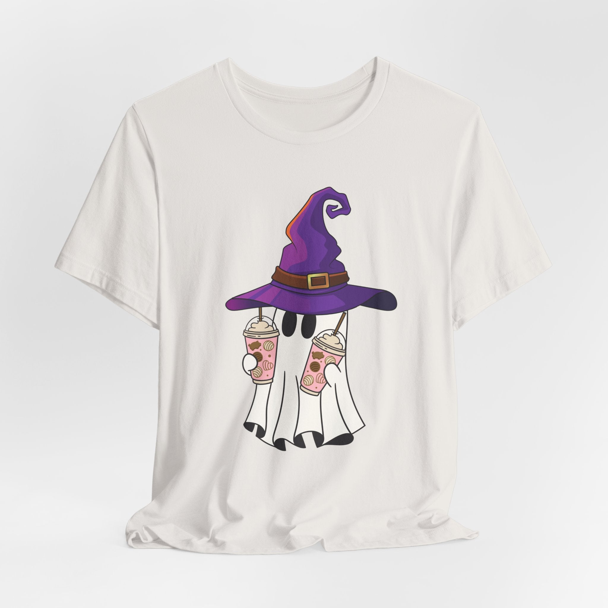 Vintage white t-shirt with ghost and purple witch hat graphic holding two cups of  juice on a light gray background 