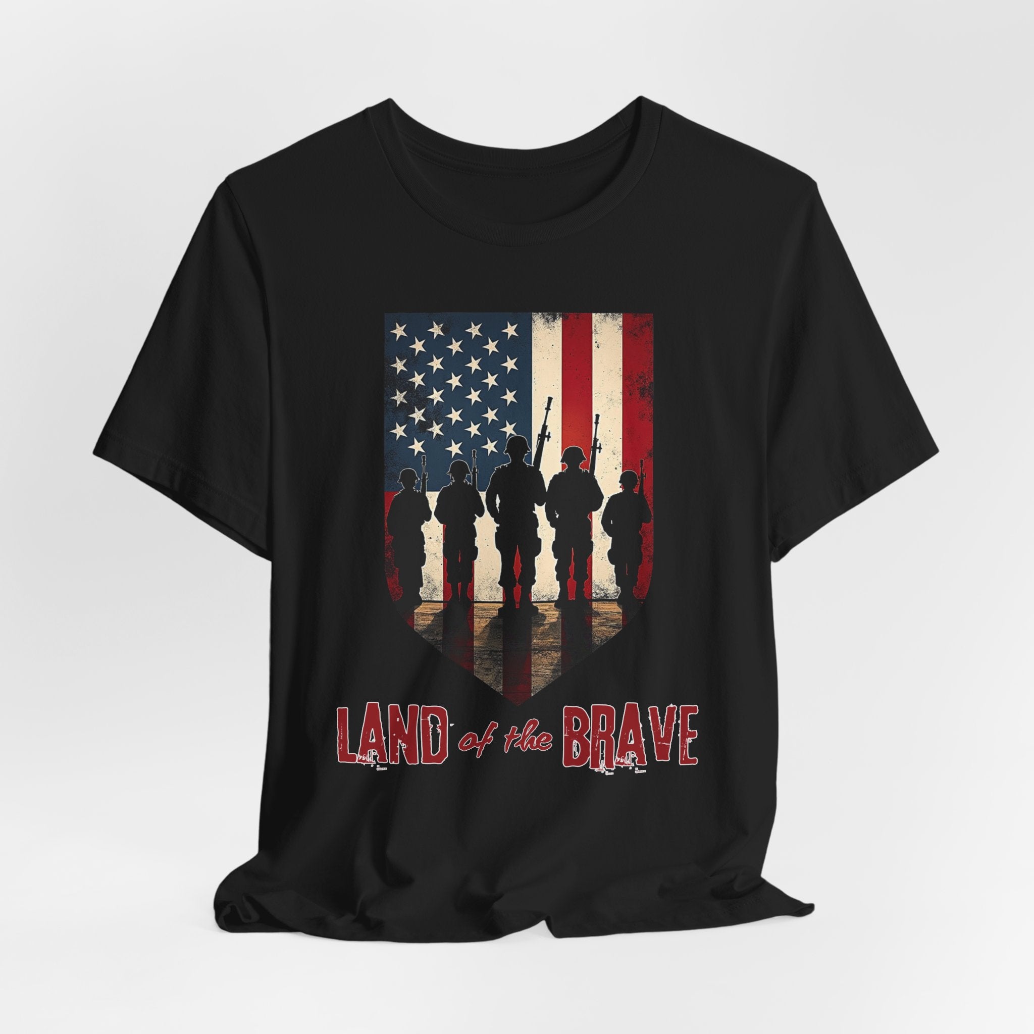 Black t-shirt with vintage American flag, soldiers, and silhouette design with land of the brave text on a white background